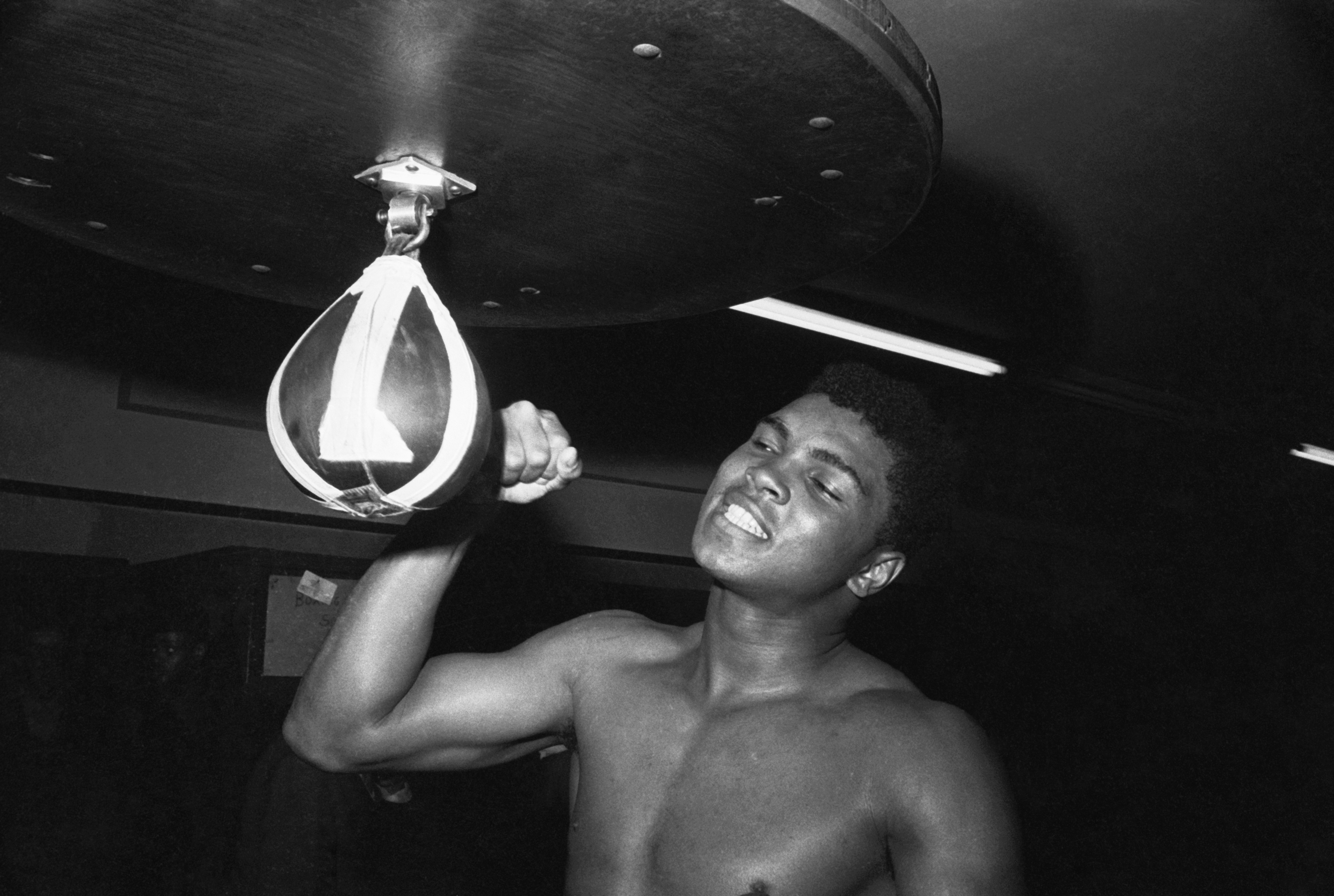Muhammad Ali punches a bag