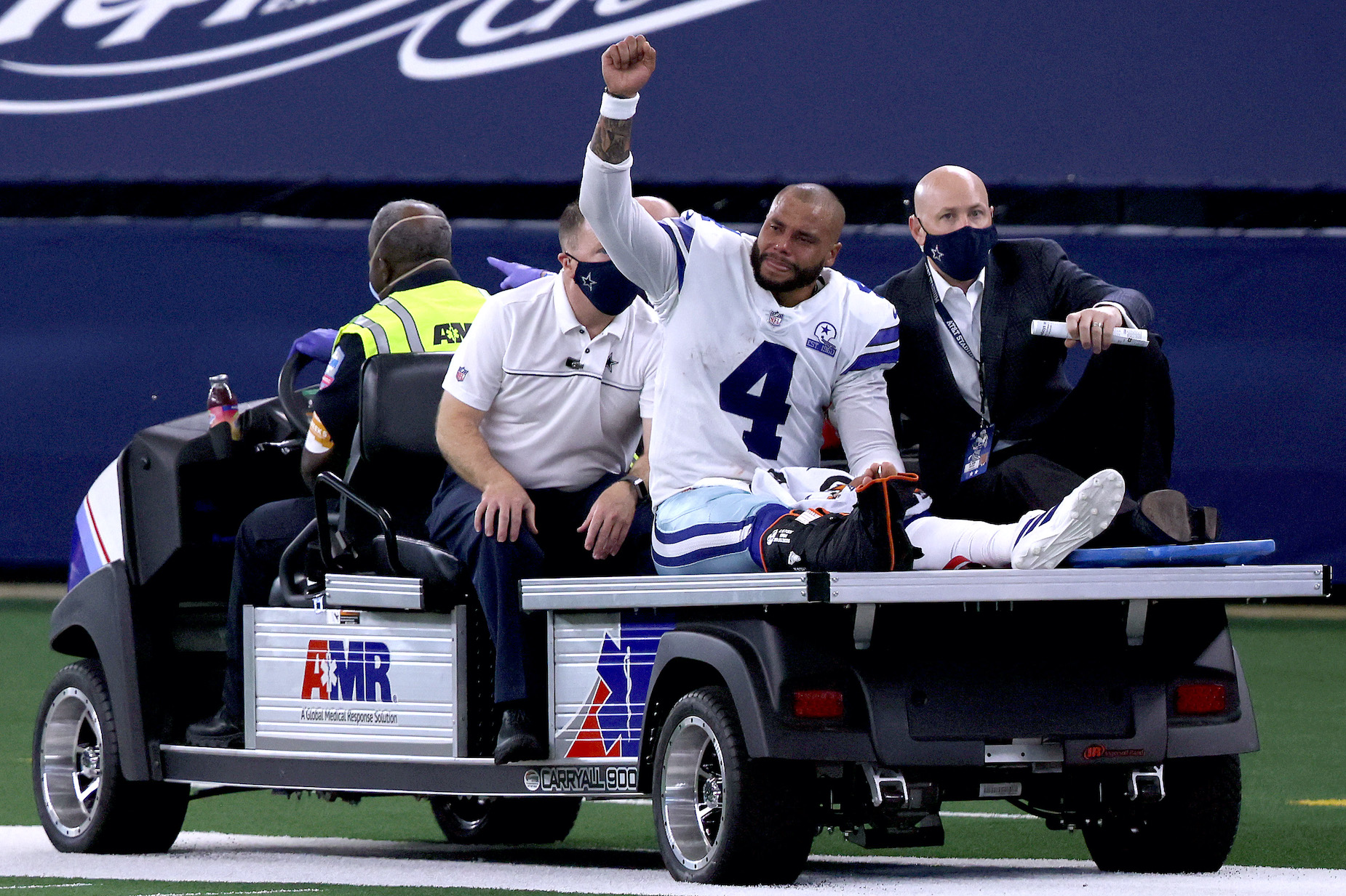 Dallas Cowboys quarterback Dak Prescott leaves the field after injuring his ankle.