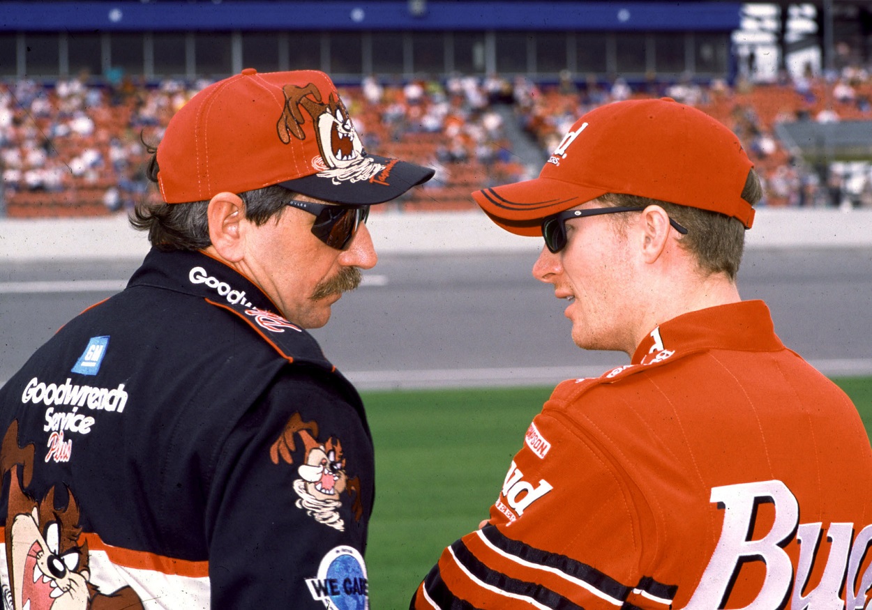 Dale Earnhardt Sr. and Dale Earnhardt Jr. talk ahead of a NASCAR Cup Series race