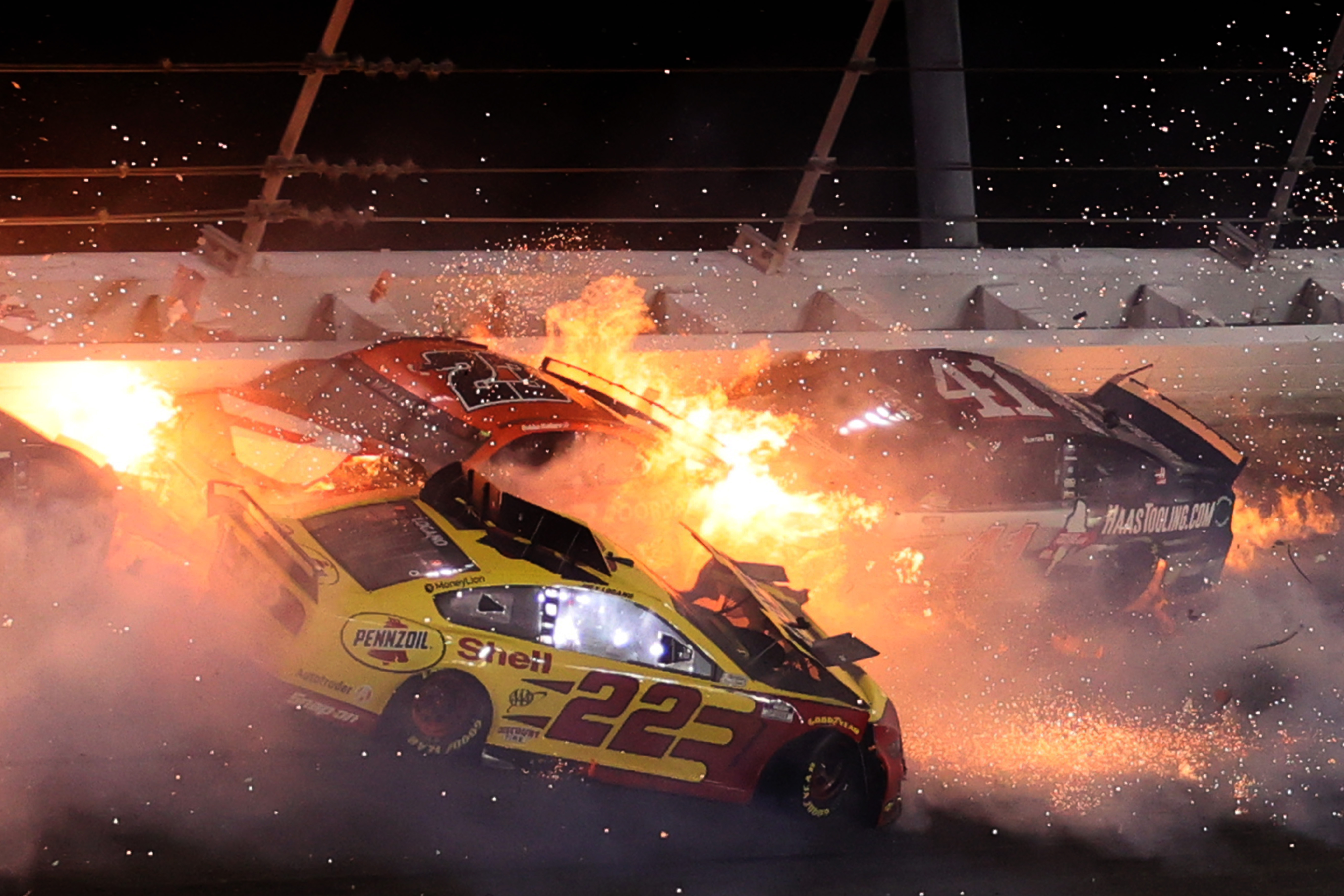 Joey Logano, driver of the #22 Shell Pennzoil Ford, Bubba Wallace, driver of the #23 DoorDash Toyota, and Cole Custer, driver of the #41 HaasTooling.com Ford, are involved in an on-track incident during the NASCAR Cup Series Daytona 500 at Daytona International Speedway in 2021