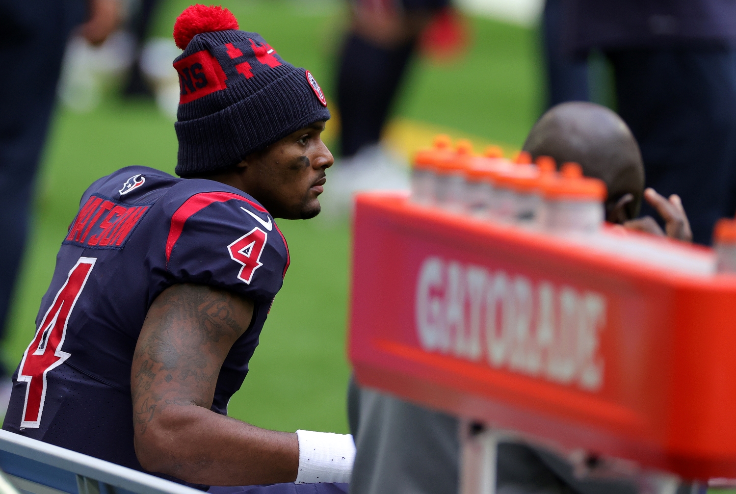 Deshaun Watson sits on the bench during a Houston Texans game.