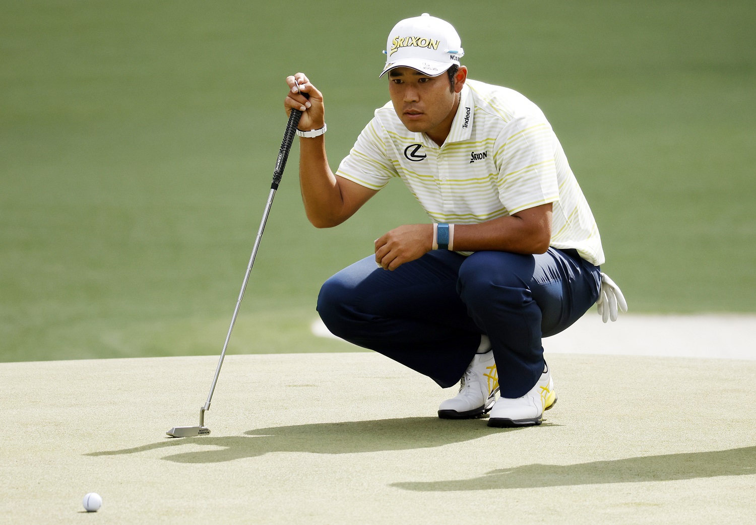 Hideki Matsuyama of Japan looks over a putt on the sixth green during the final round of The Masters at Augusta National Golf Club on April 11, 2021.
