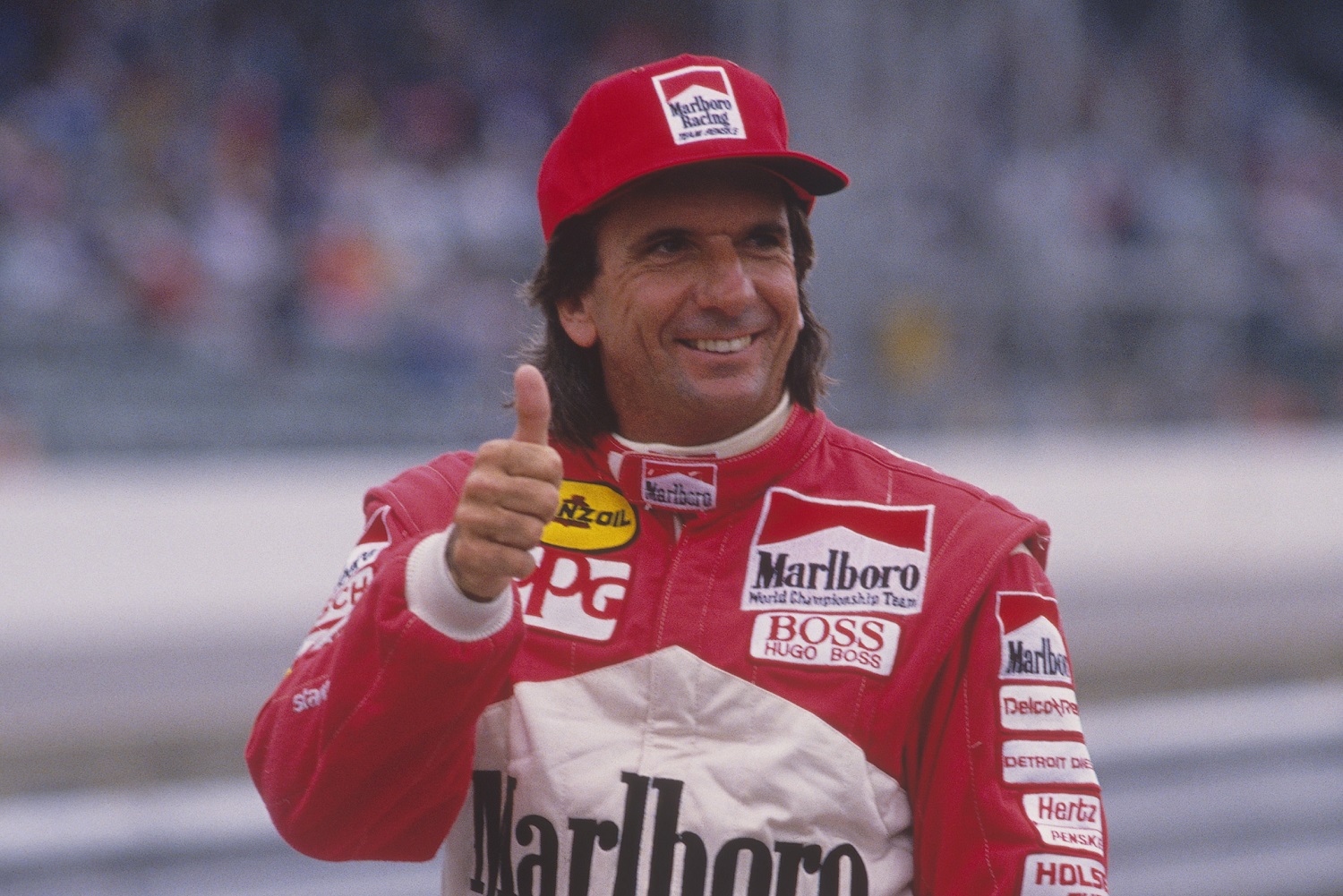 Brazil's Emerson Fittipaldi posing for cameras in his Indy car during time trials for the Indianapolis 500 at the Indianapolis Motor Speedway on May 30, 1993,