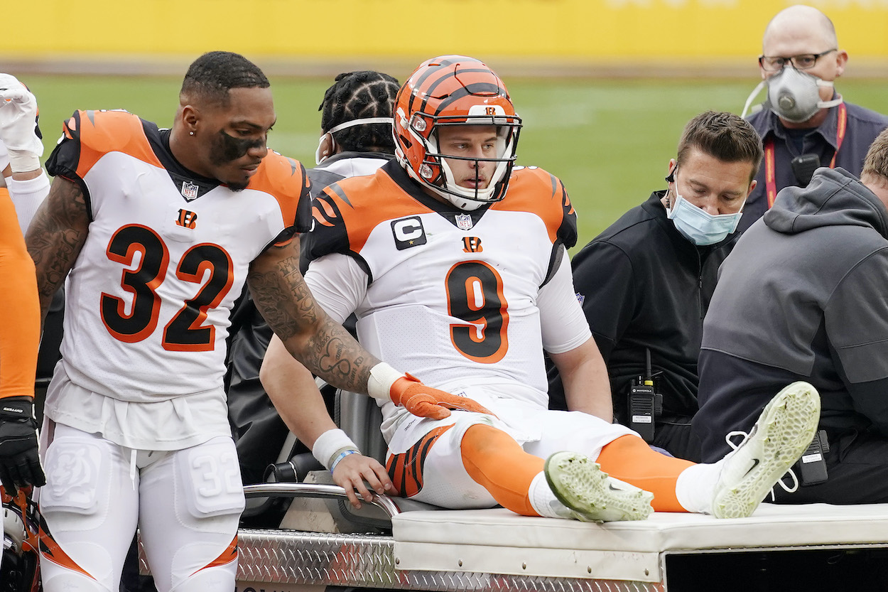 Joe Burrow of the Cincinnati Bengals is carted off the field after injuring his left knee in the third quarter against the Washington Football Team at FedExField on November 22, 2020 in Landover, Maryland.