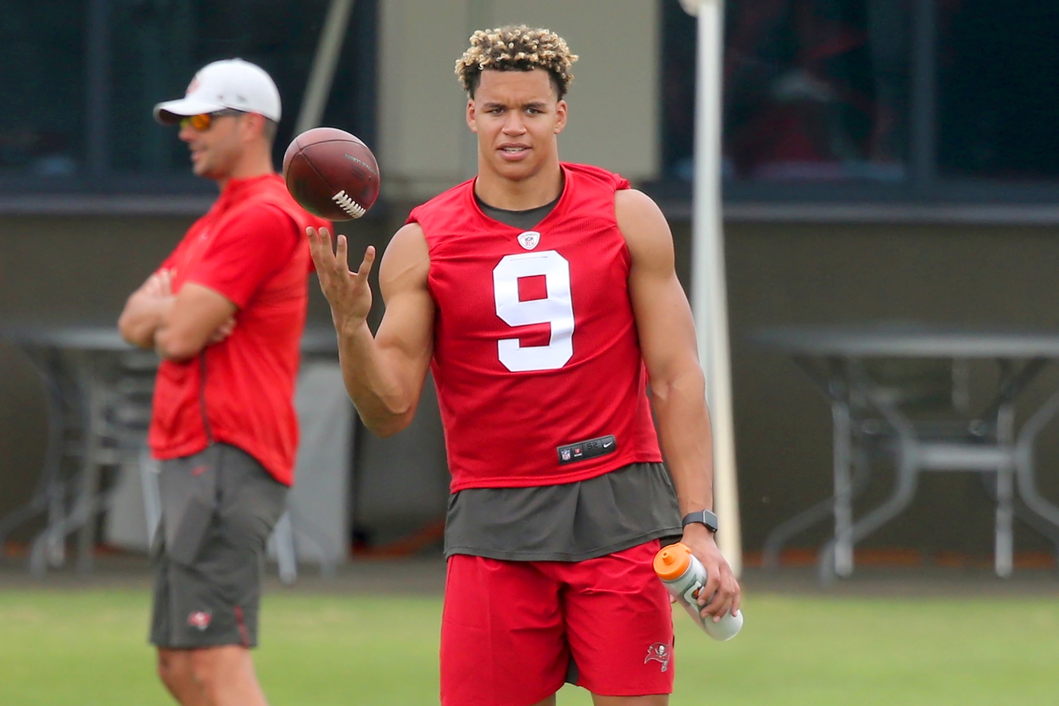 Buccaneers first-round pick Joe Tryon balances a football on his finger during practice.
