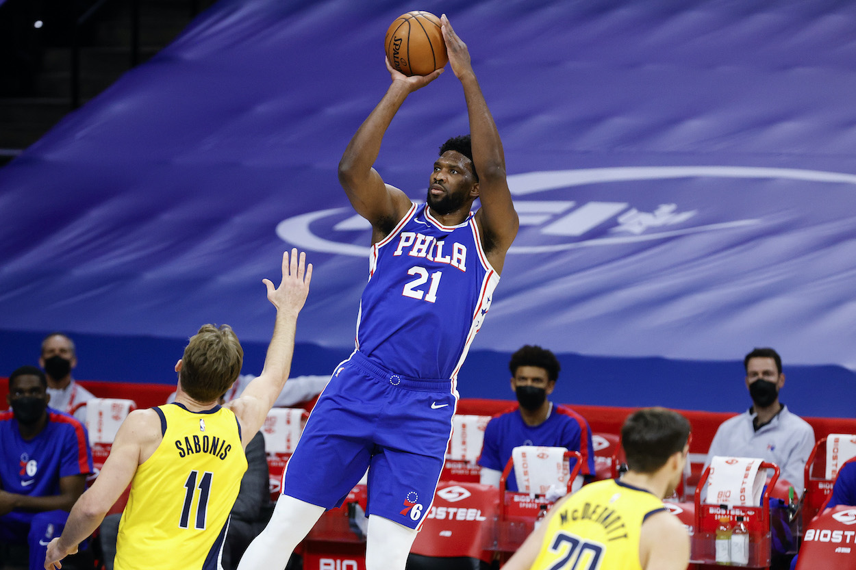 Joel Embiid getting a shot up over Damontas Sabonis