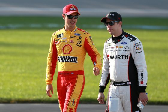 Joey Logano and Brad Keselowski walk together before qualifying