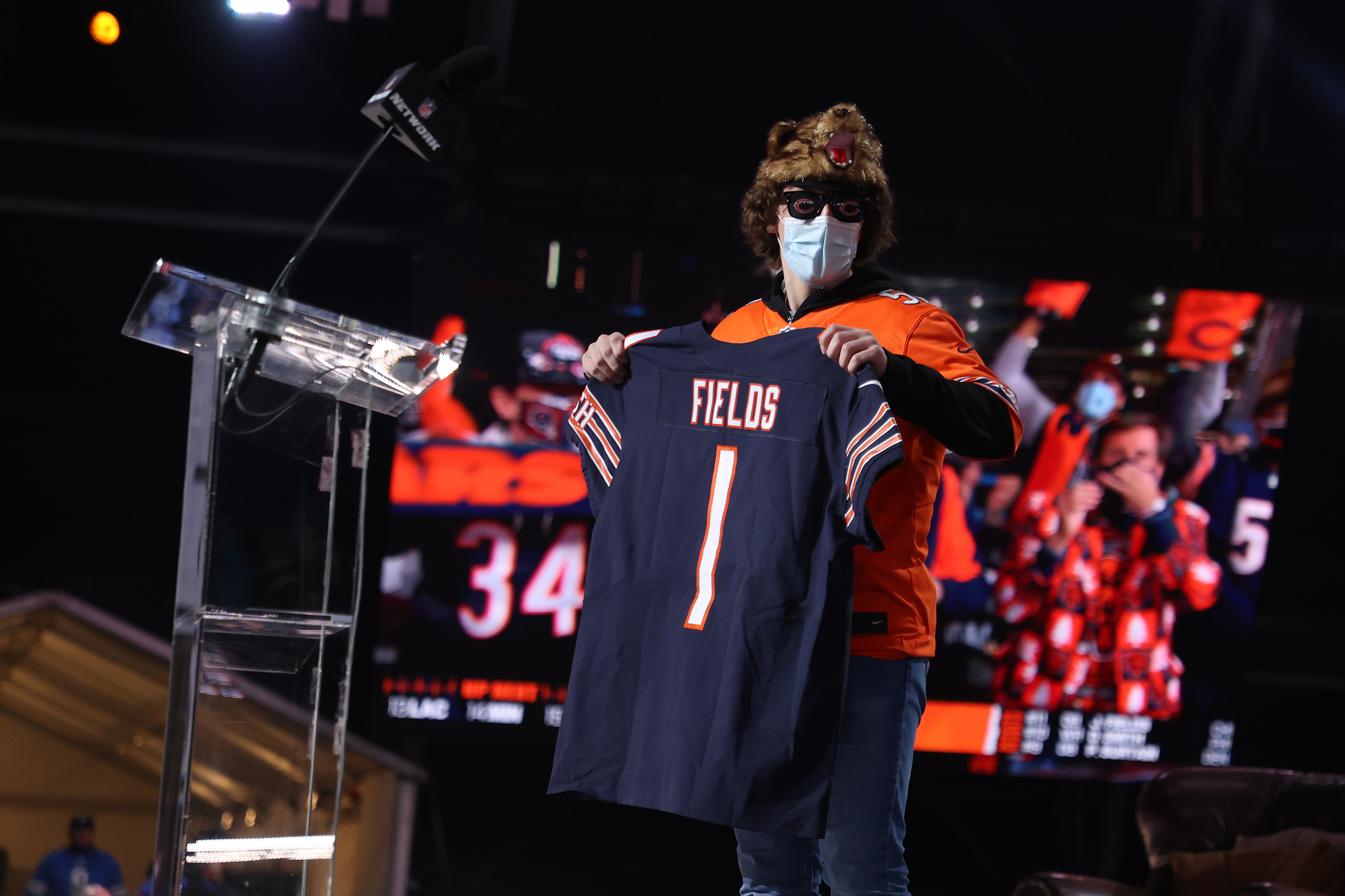 A fan holds a jersey after NFL Commissioner Roger Goodell announced Justin Fields being selected by the Chicago Bears during round one of the 2021 NFL Draft at the Great Lakes Science Center on April 29, 2021 in Cleveland, Ohio.