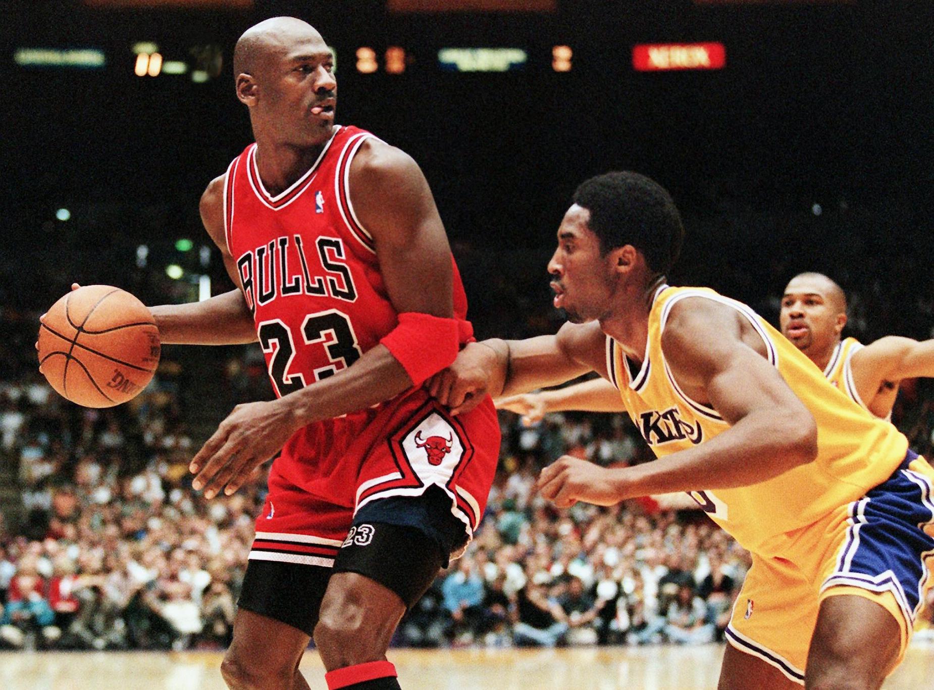 Kobe Bryant defends Michael Jordan during a 1998 NBA game.