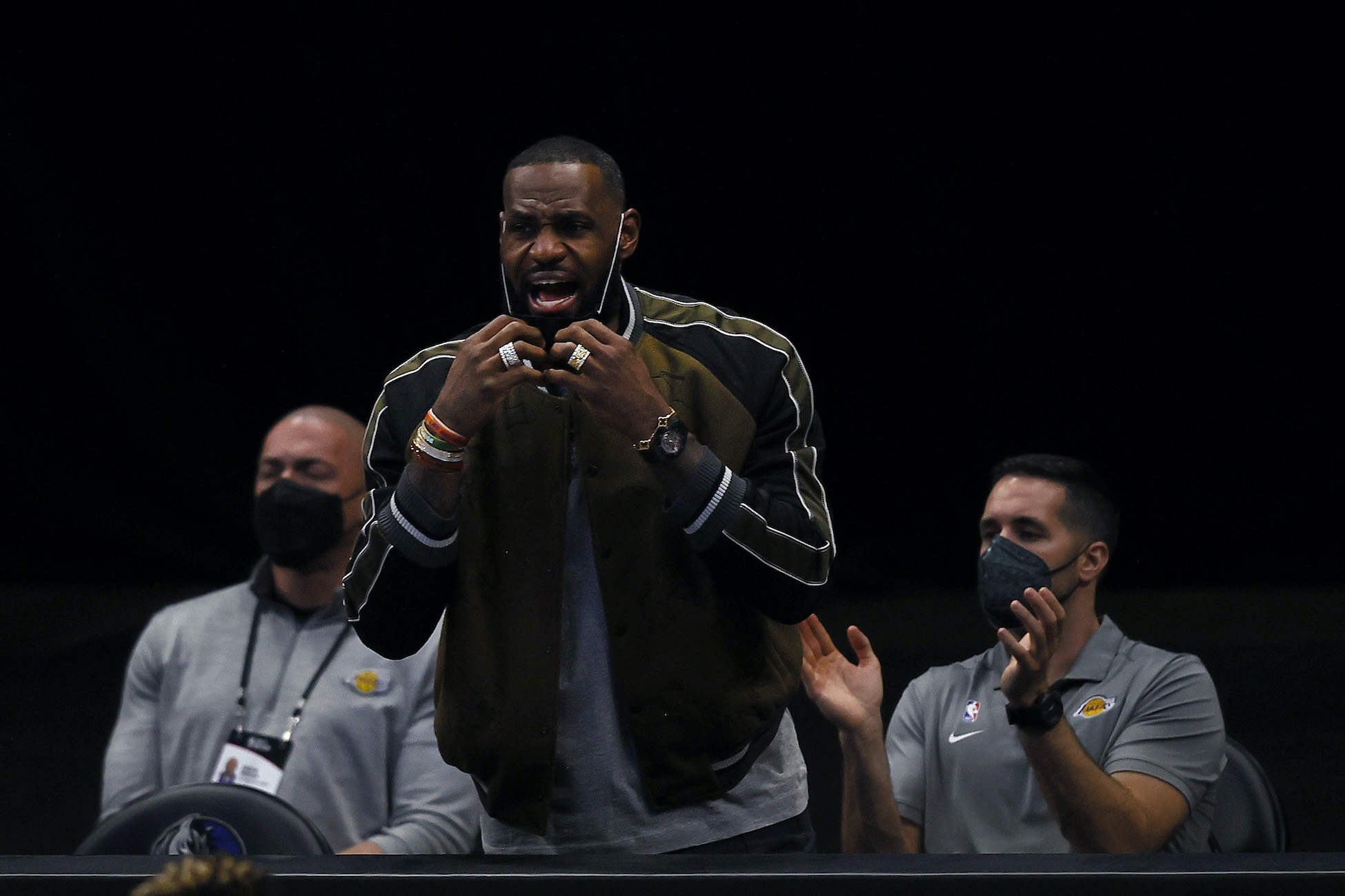 LeBron James reacts during a LA Lakers game while sidelined with an ankle injury.