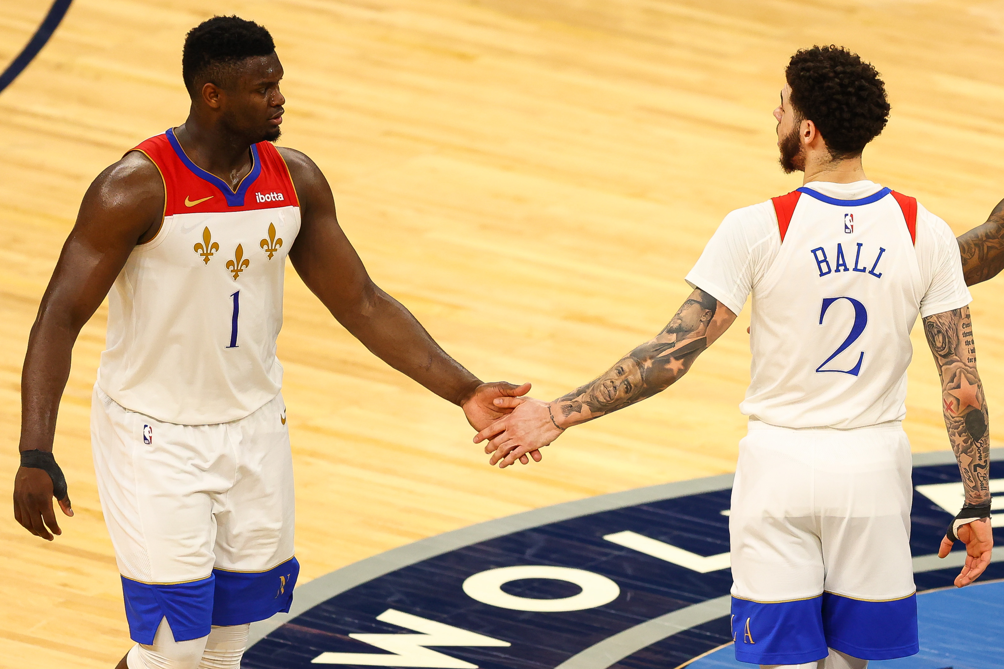 Zion Williamson and Lonzo Ball of the New Orleans Pelicans celebrate after a play during over time against the Minnesota Timberwolves at Target Center on May 1, 2021.
