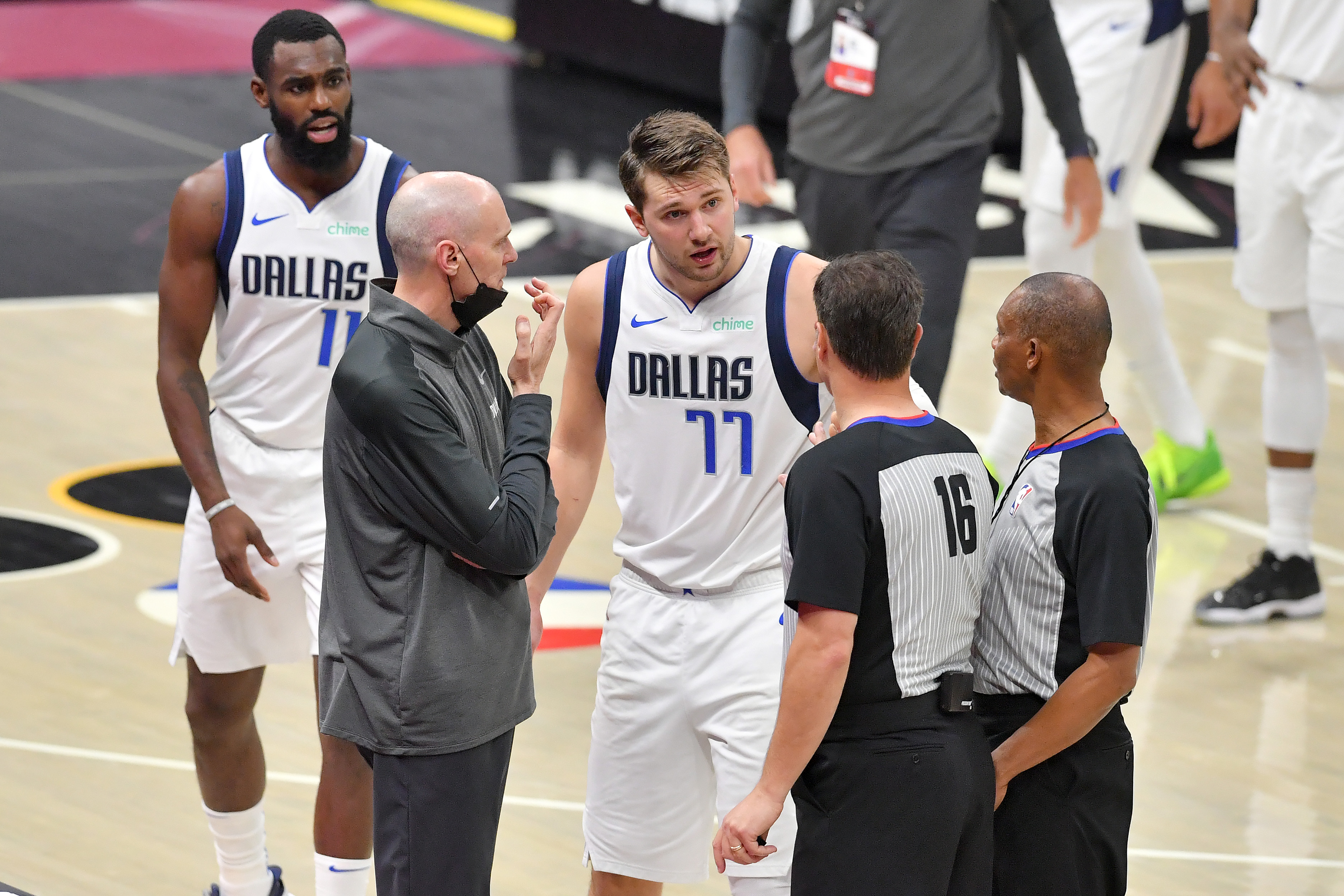 Head coach Rick Carlisle and Luka Doncic of the Dallas Mavericks argue with referees David Guthrie and Michael Smith during the third quarter of the game between the Dallas Mavericks and the Cleveland Cavaliers at Rocket Mortgage Fieldhouse on May 09, 2021 in Cleveland, Ohio.