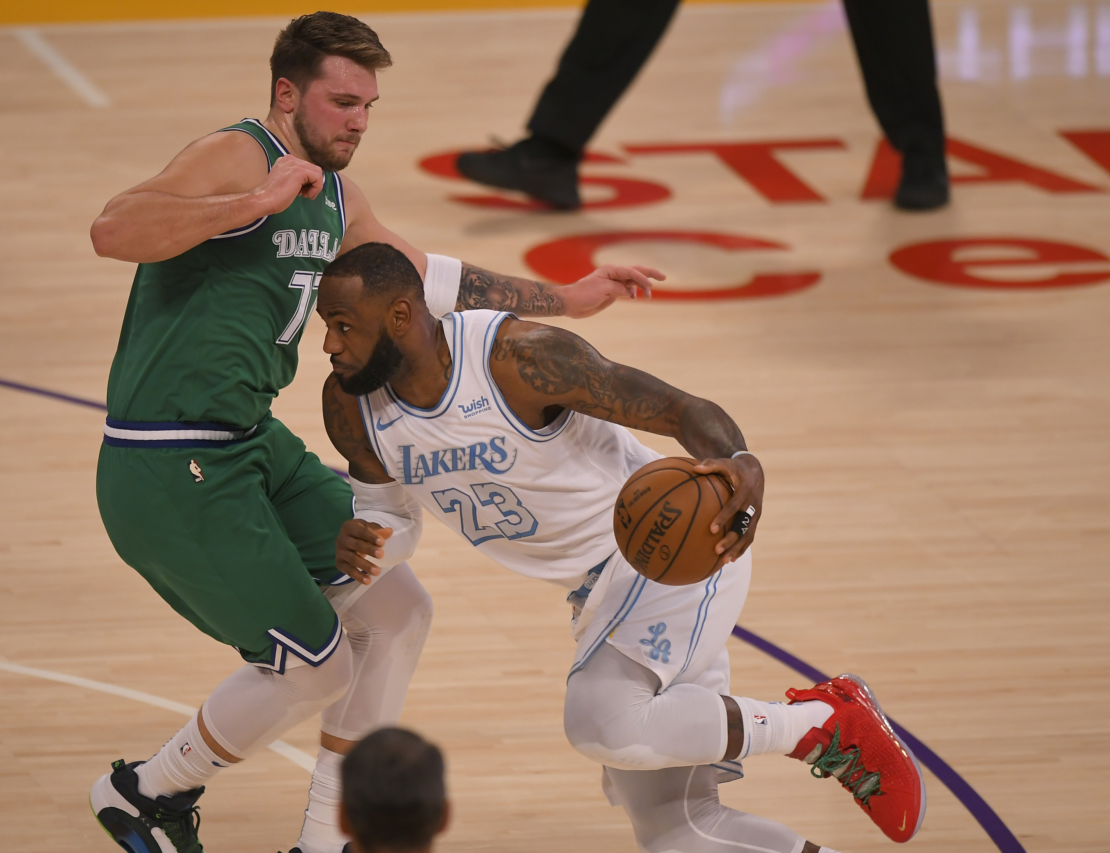 Luka Doncic of the Dallas Mavericks guards LeBron James of the Los Angeles Lakers in the first half at Staples Center on December 25, 2020 in Los Angeles, California.