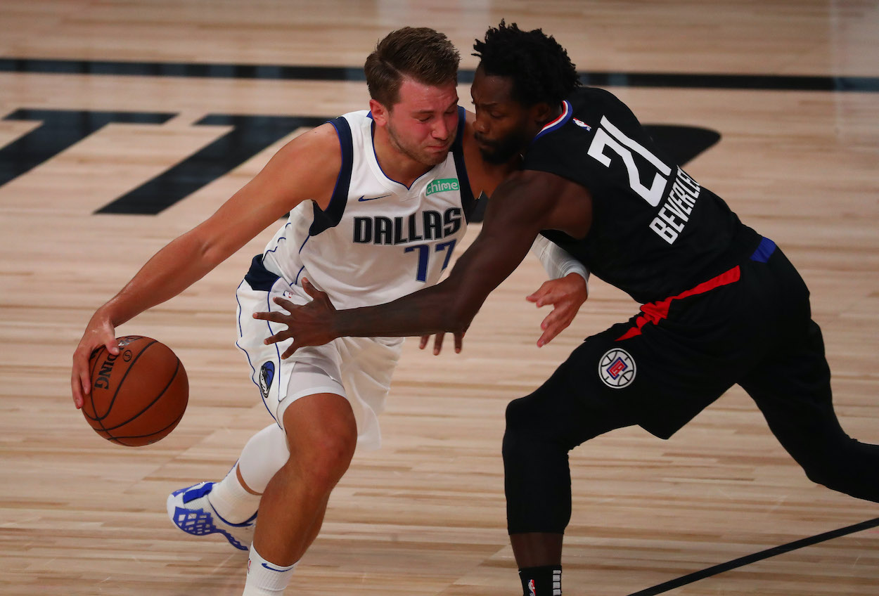 Dallas Mavericks guard Luka Doncic drives against LA Clippers guard Patrick Beverley in the first half in game one of the first round of the 2020 NBA Playoffs at AdventHealth Arena.