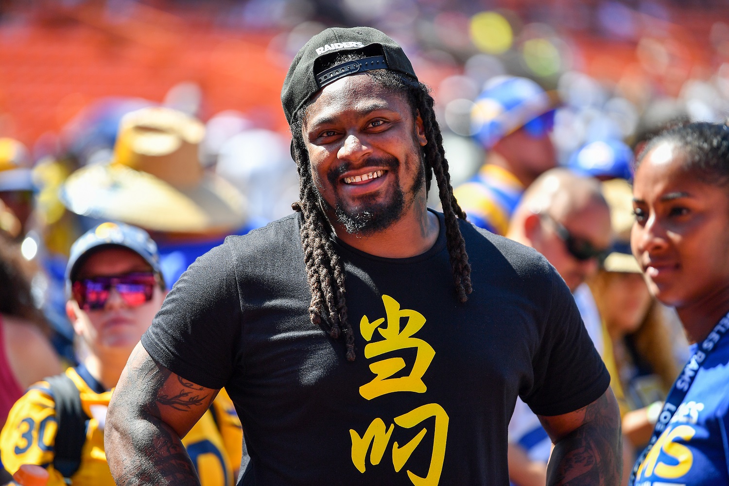 Marshawn Lynch is all smiles before the preseason game between the Dallas Cowboys and the Los Angeles Rams on Aug. 17, 2019, in Honolulu,