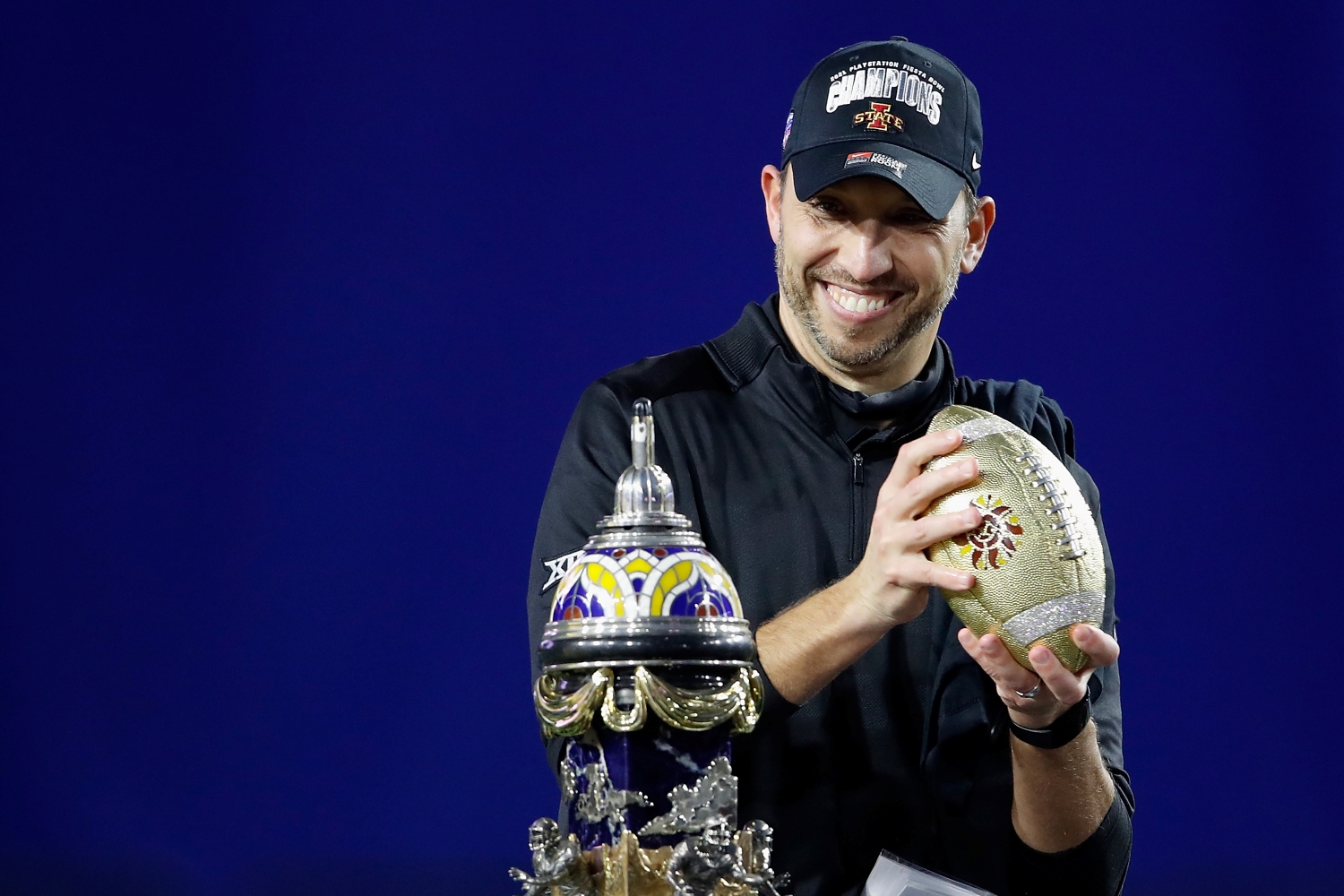 Iowa State head coach Matt Campbell celebrates winning the Fiesta Bowl on stage.