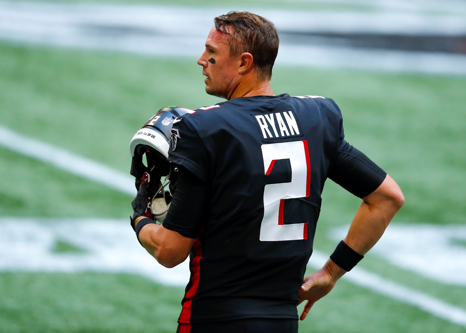 Atlanta Falcons quarterback Matt Ryan stands with his helmet off before a game against the Chicago Bears.
