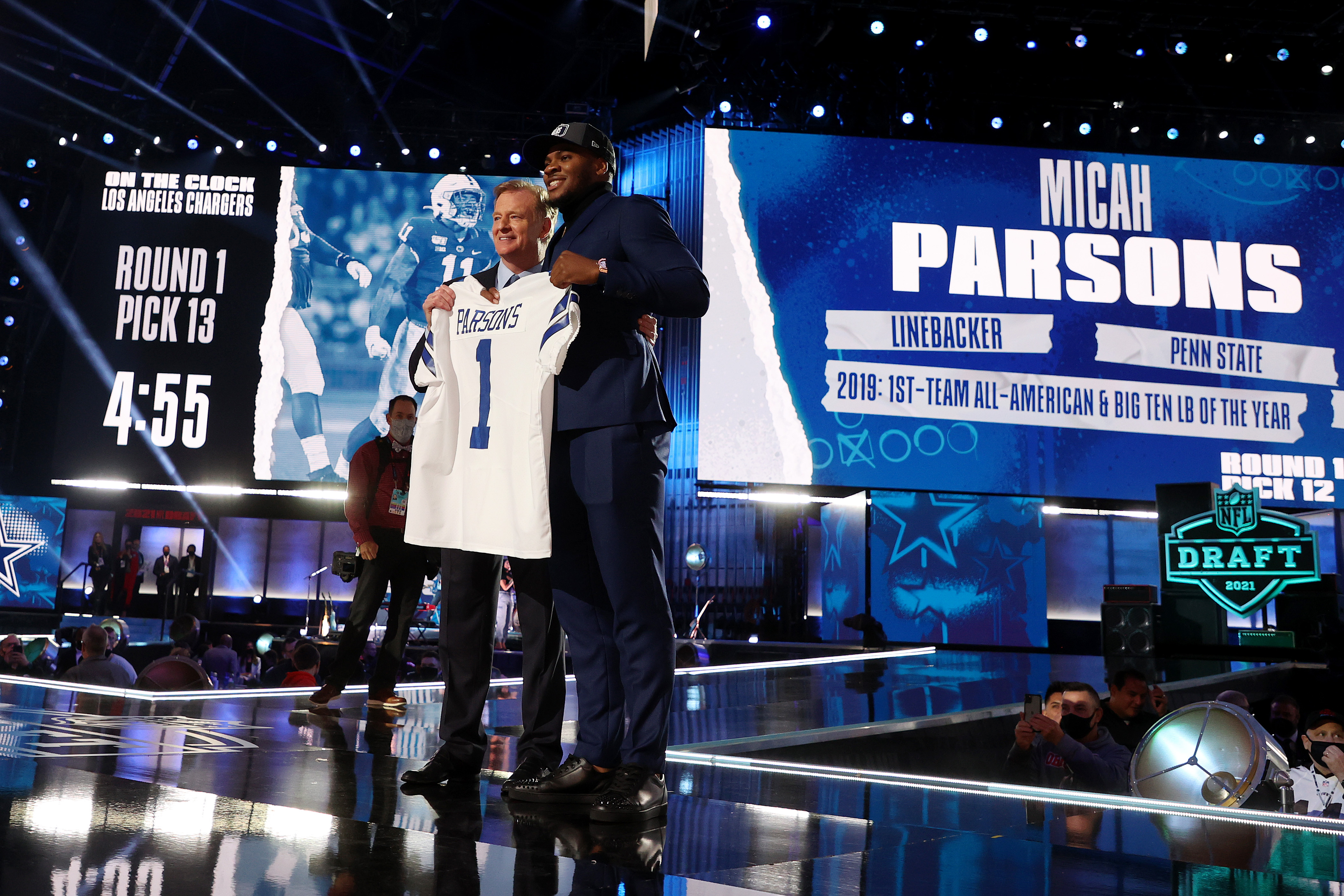 Dallas Cowboy draft pick Micah Parsons poses with NFL Commissioner Roger Goodell onstage during round one of the 2021 NFL Draft at the Great Lakes Science Center on April 29, 2021 in Cleveland, Ohio.