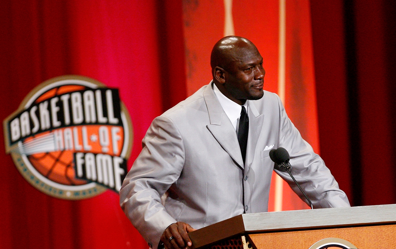 Michael Jordan stands at the podium during his induction into the Naismith Memorial Basketball Hall of Fame.