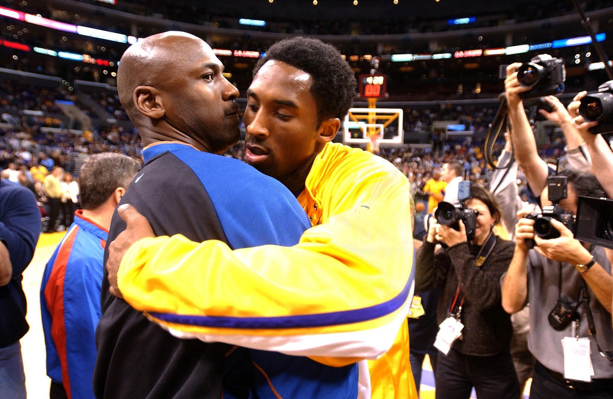 Michael Jordan and Kobe Bryant embrace ahead of a Wizards-Lakers matchup in February 2002