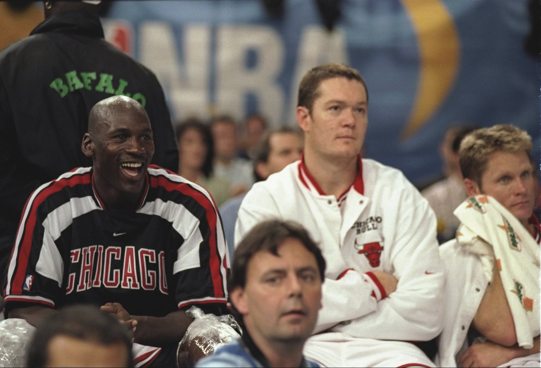 Michael Jordan (L) and Luc Longley (R) sit together on the bench as members of the Chicago Bulls.