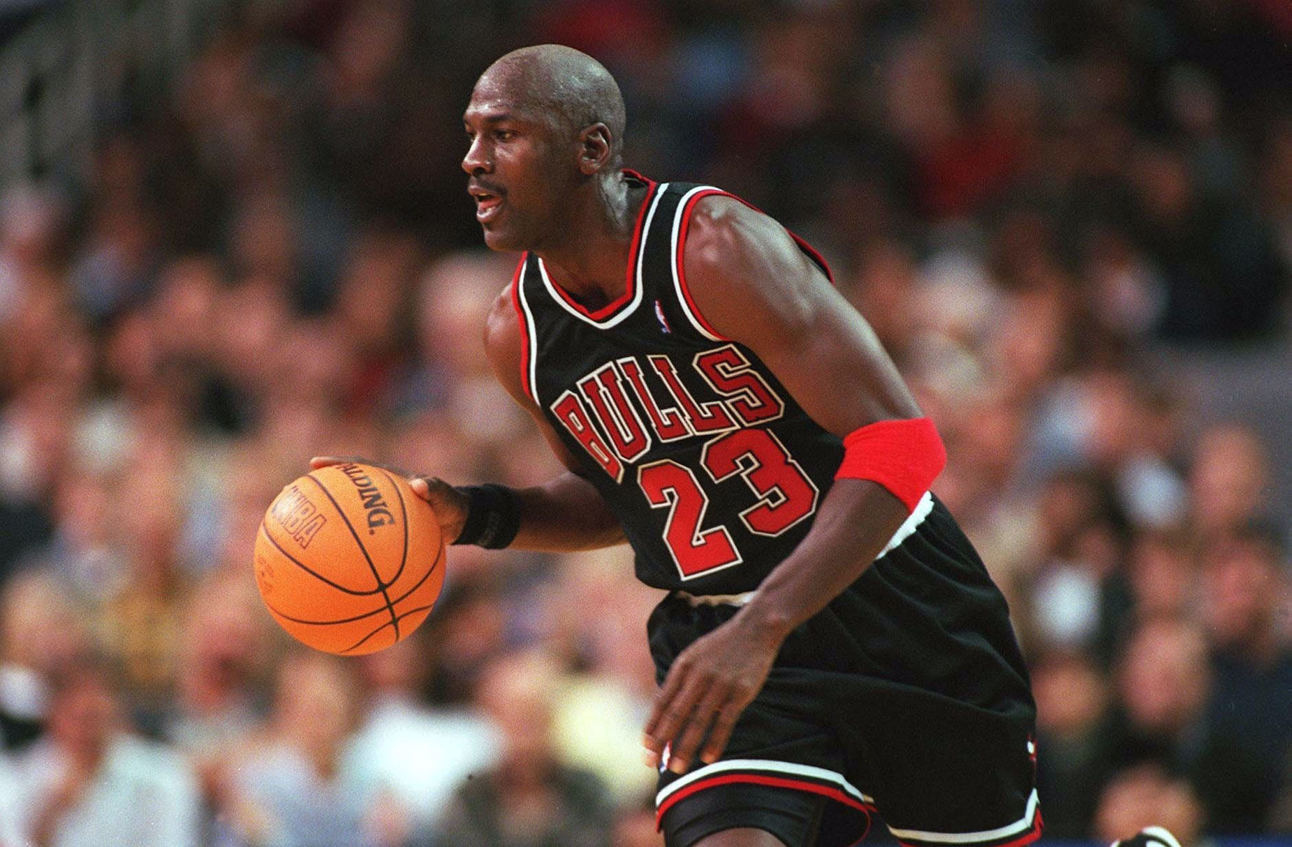 Michael Jordan dribbles the ball up the court as a member of the Chicago Bulls.