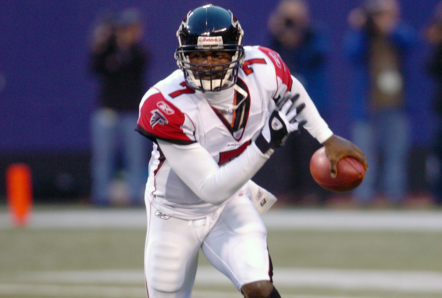Michael Vick of the Atlanta Falcons runs with the ball against the New York Giants during an NFL game on Nov. 21, 2004. at MetLife Stadium in East Rutherford, New Jersey.
