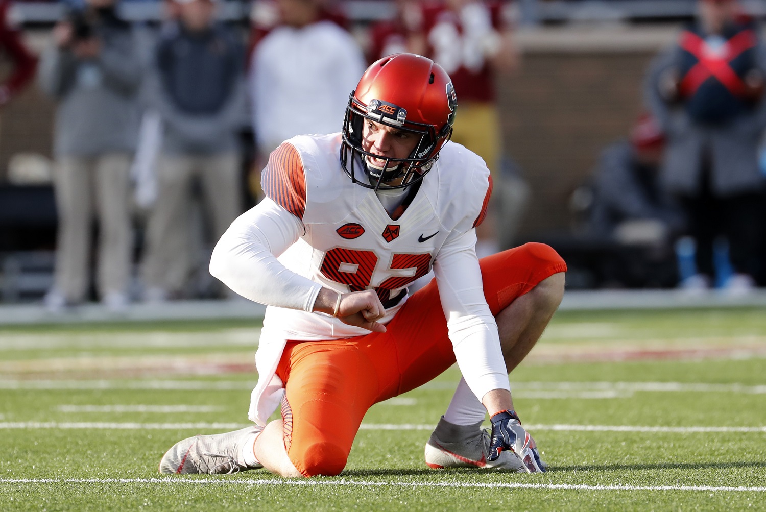 Nolan Cooney prepares to hold on an extra-point attempt for Syracuse University against Boston College in 2018.