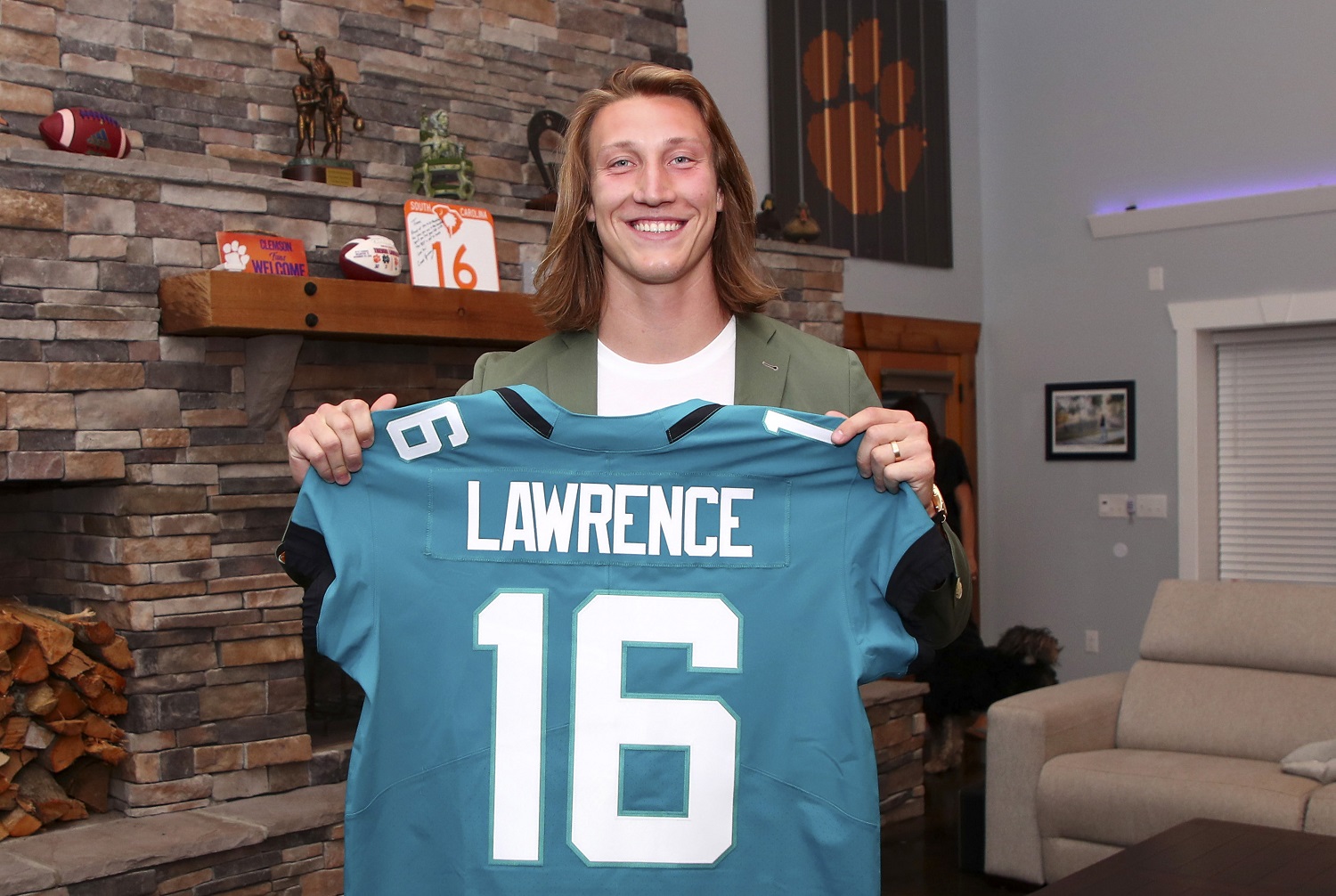 Trevor Lawrence poses after being selected with the first overall pick by the Jacksonville Jaguars in the 2021 NFL Draft. | Logan Bowles/NFL via Getty Images