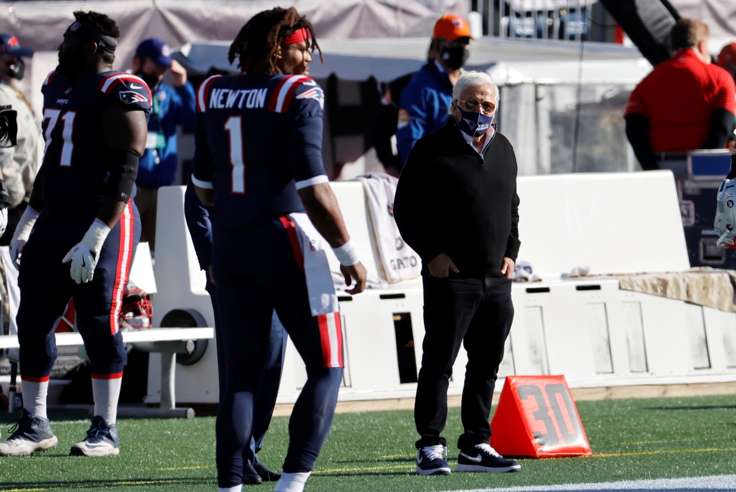 Patriots owner Robert Kraft watches Cam Newton warming up from the sideline.