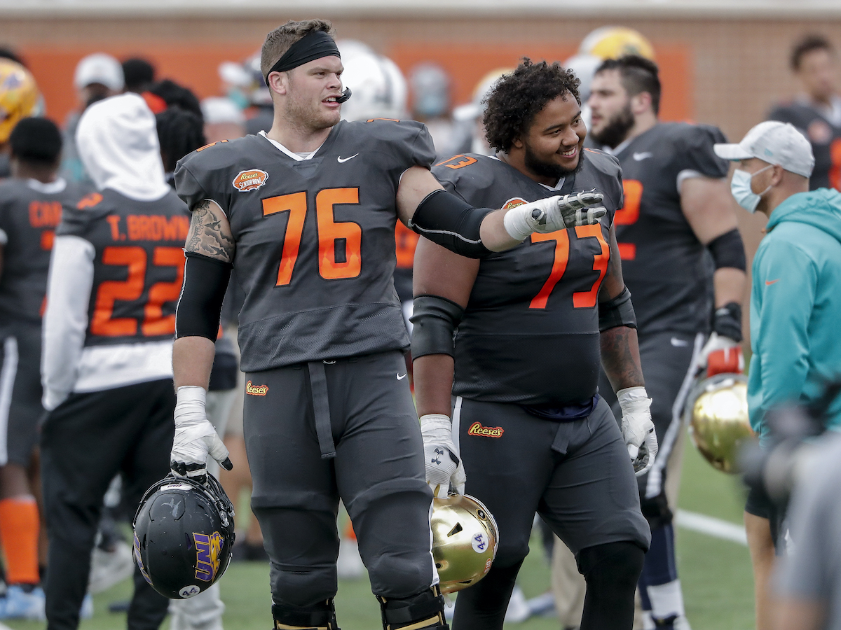 New Buffalo Bills Offensive Linemen Spencer Brown from Northern Iowa and Aaron Banks from Notre Dame of the National Team on the sidelines during the 2021 Resse's Senior Bowl at Hancock Whitney Stadium on the campus of the University of South Alabama on January 30, 2021 in Mobile, Alabama.