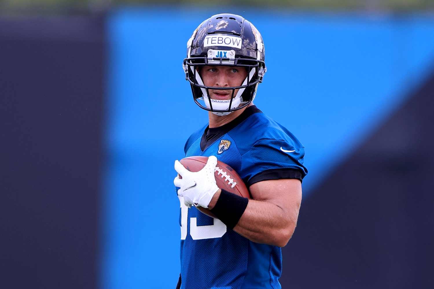 Jacksonville Jaguars tight end Tim Tebow holds a ball during practice.