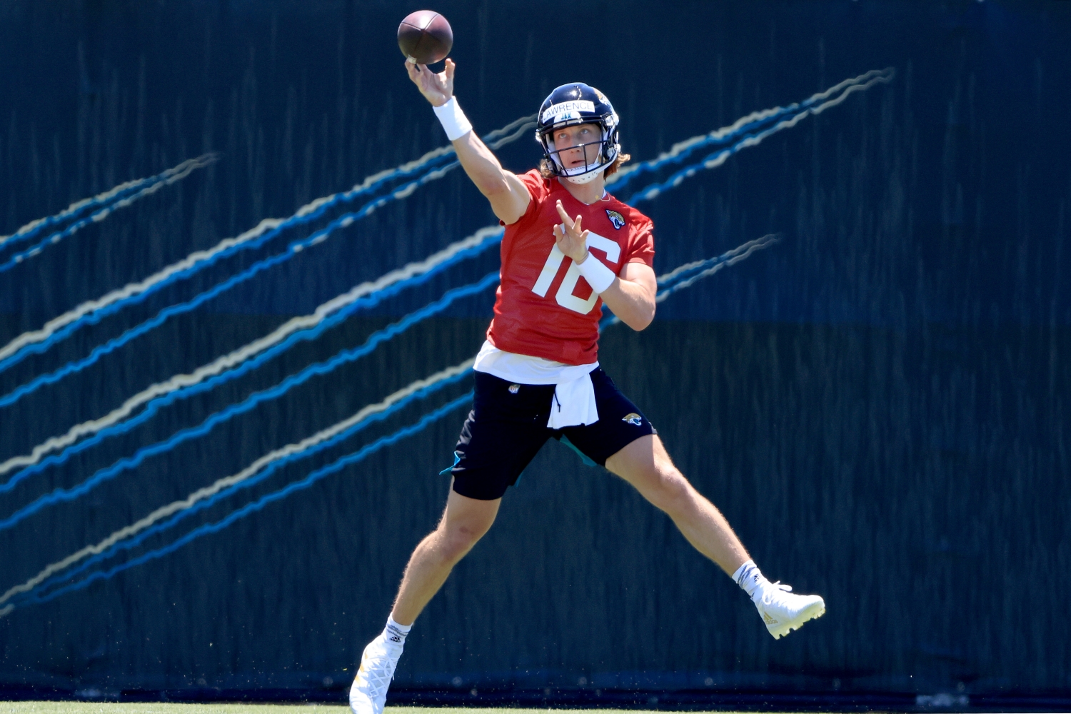 Top 2021 NFL draft pick Trevor Lawrence throws the ball on the run during Jaguars practice on May 15, 2021.