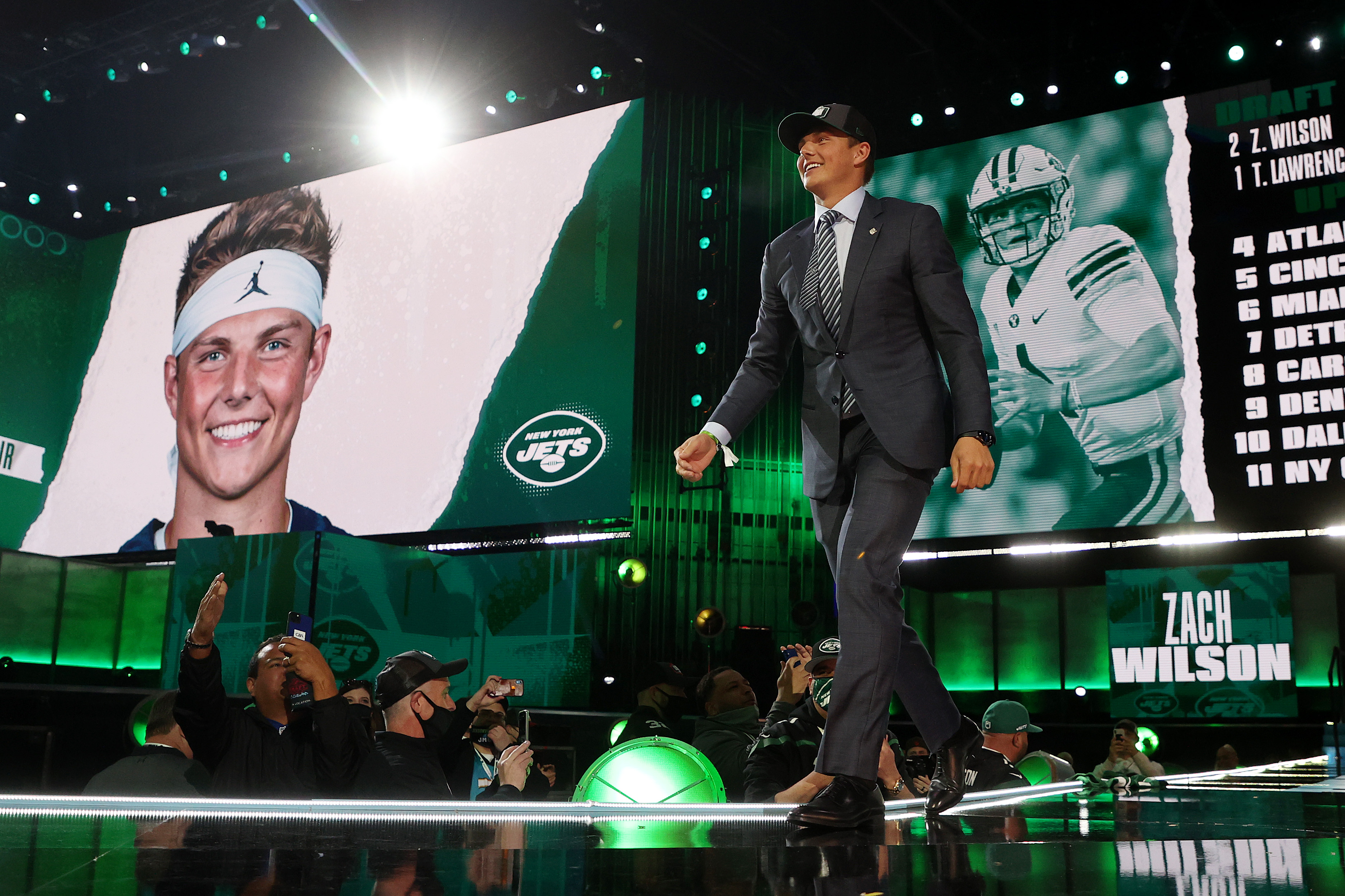 Zach Wilson walks onstage after being drafted second by the New York Jets during round one of the 2021 NFL Draft.