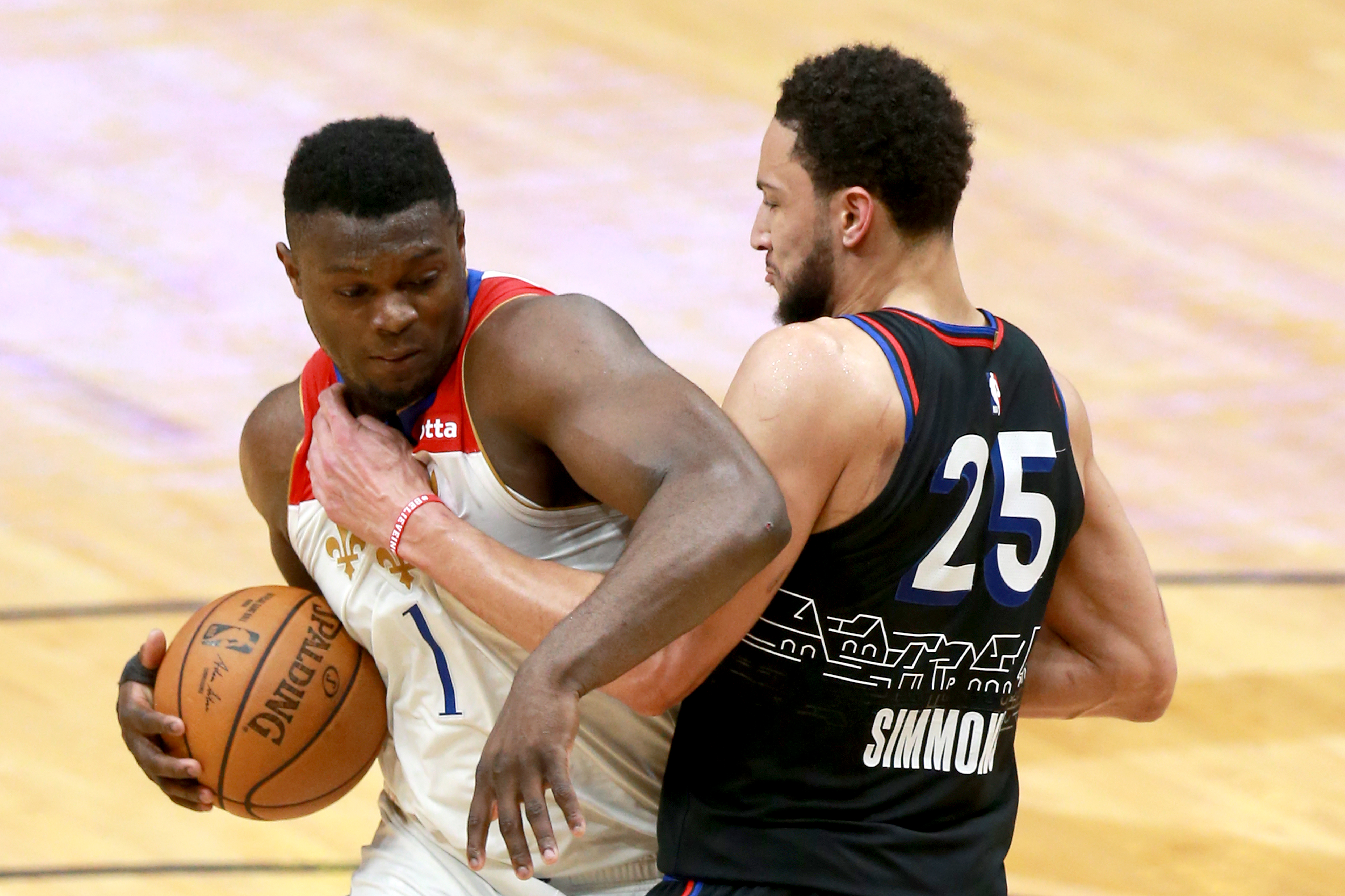 Zion Williamson of the New Orleans Pelicans is defended by Ben Simmons of the Philadelphia 76ers during the third quarter of an NBA game at Smoothie King Center on April 09, 2021 in New Orleans, Louisiana.