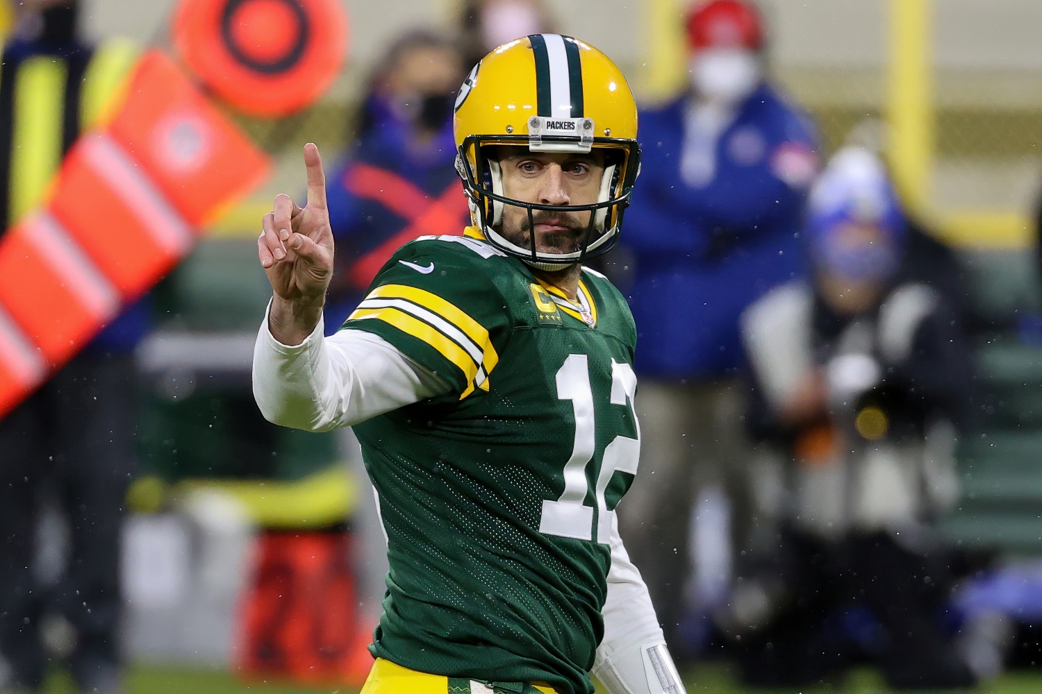 Green Bay Packers QB Aaron Rodgers signals to the sideline during a game.