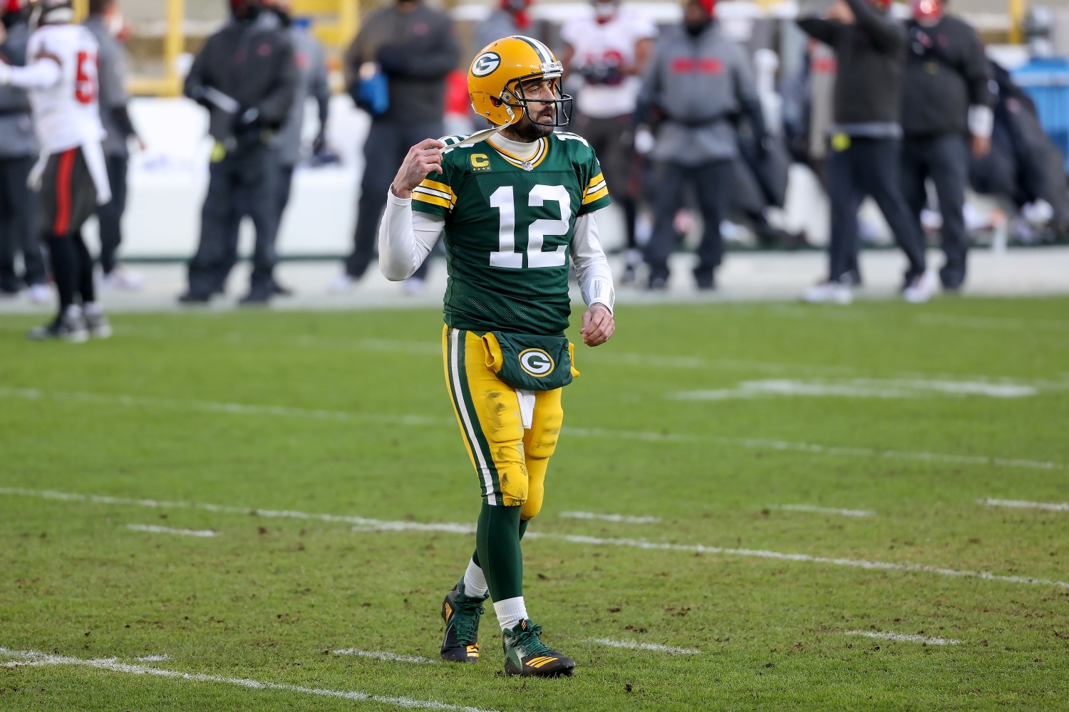 Green Bay Packers quarterback Aaron Rodgers walks across the field during the second quarter of the NFC Championship.
