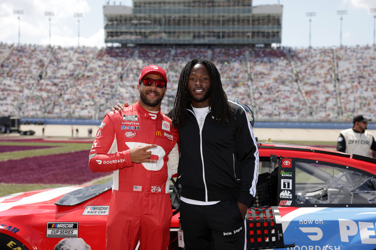 NFL player Alvin Kamara NASCAR's new ambassador and New Orleans Saints running back with Bubba Wallace, driver of the DoorDash/PetSmart Toyota, pose for photos on the grid prior to the NASCAR Cup Series Ally 400 at Nashville Superspeedway on June 20, 2021.