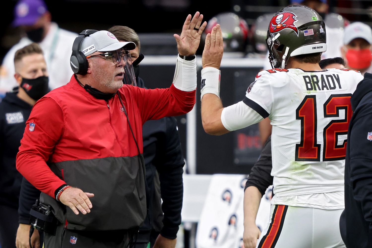 Tampa Bay Buccaneers head coach Bruce Arians greets Tom Brady as he walks off the field.
