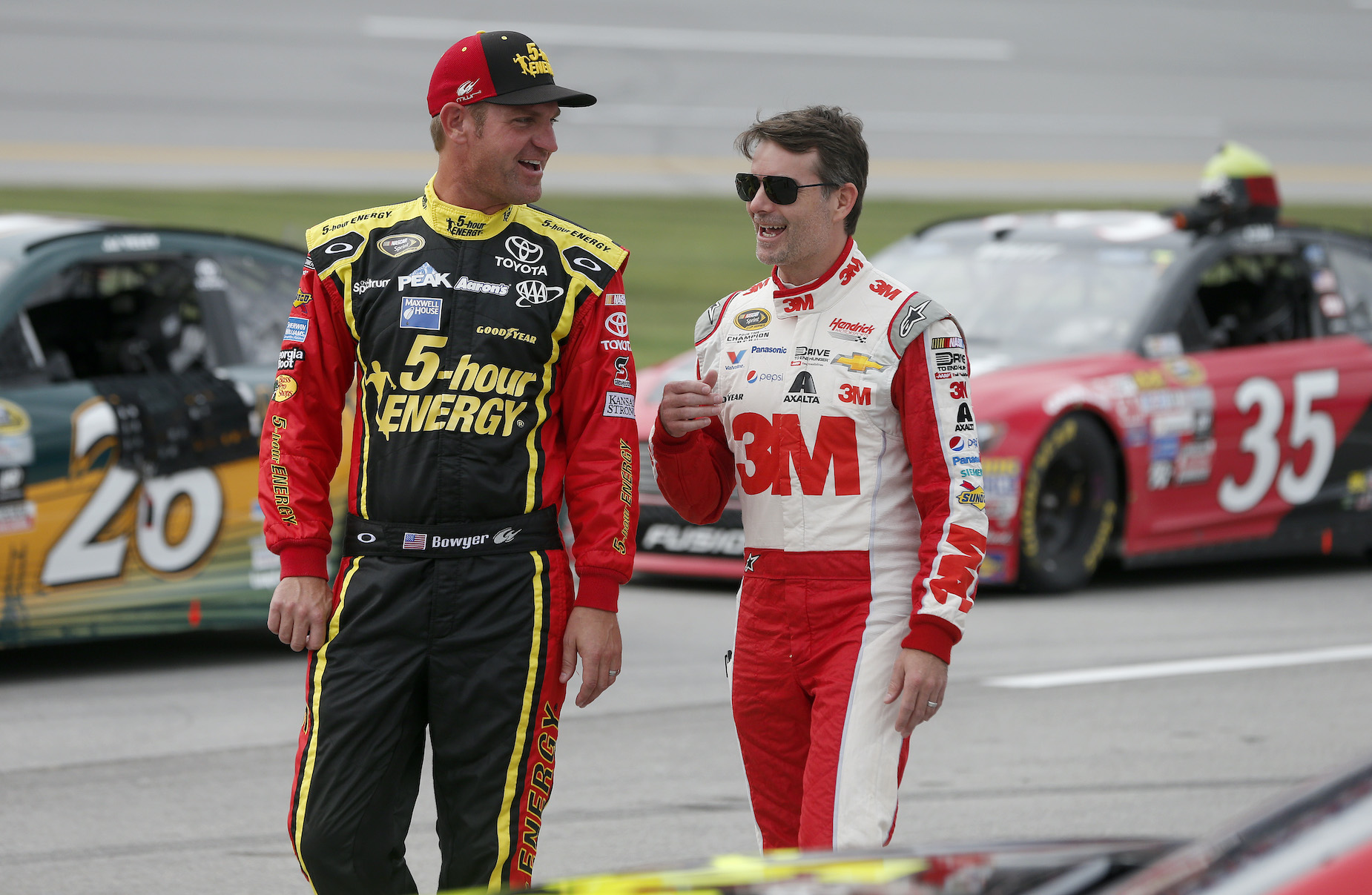 Clint Bowyer (L) and Jeff Gordon (R) walk and talk together on the NASCAR grid.