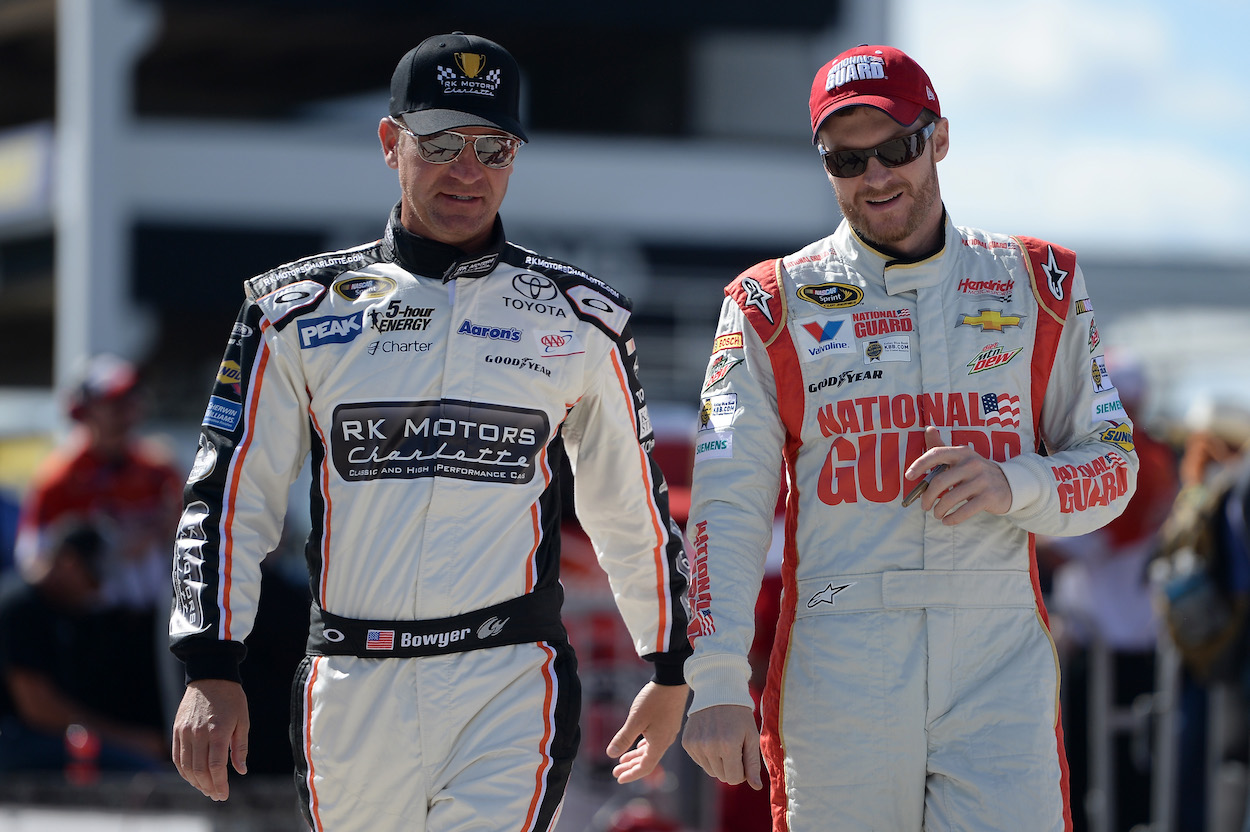 Clint Bowyer and Dale Earnhardt Jr. walk together before qualifying