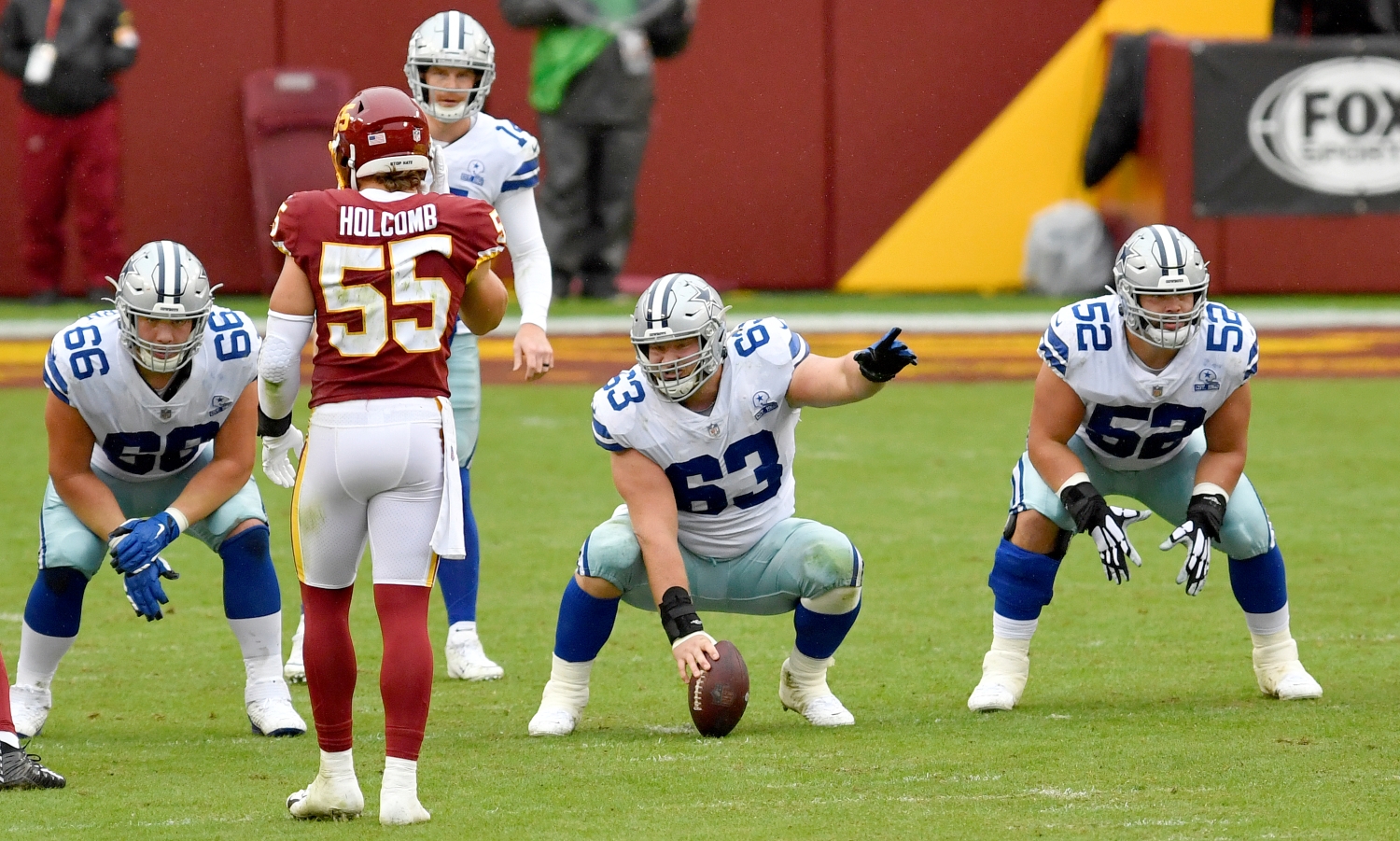 Cowboys center Tyler Biadasz points at a defender before snapping the ball.