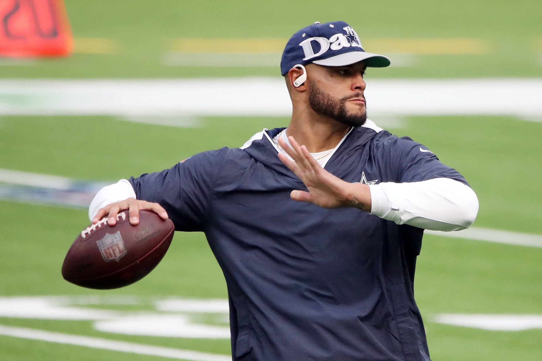 Dak Prescott throws a pass in warm-ups ahead of a Dallas Cowboys game.