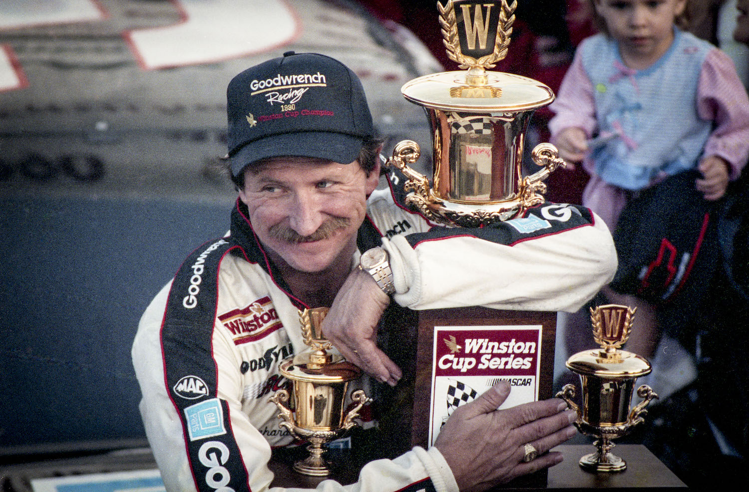 Dale Earnhardt Sr. hugs the Winston Cup trophy after clinching the 1990s championship.