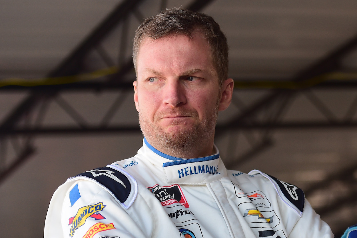 Dale Earnhardt Jr. looks on in garage