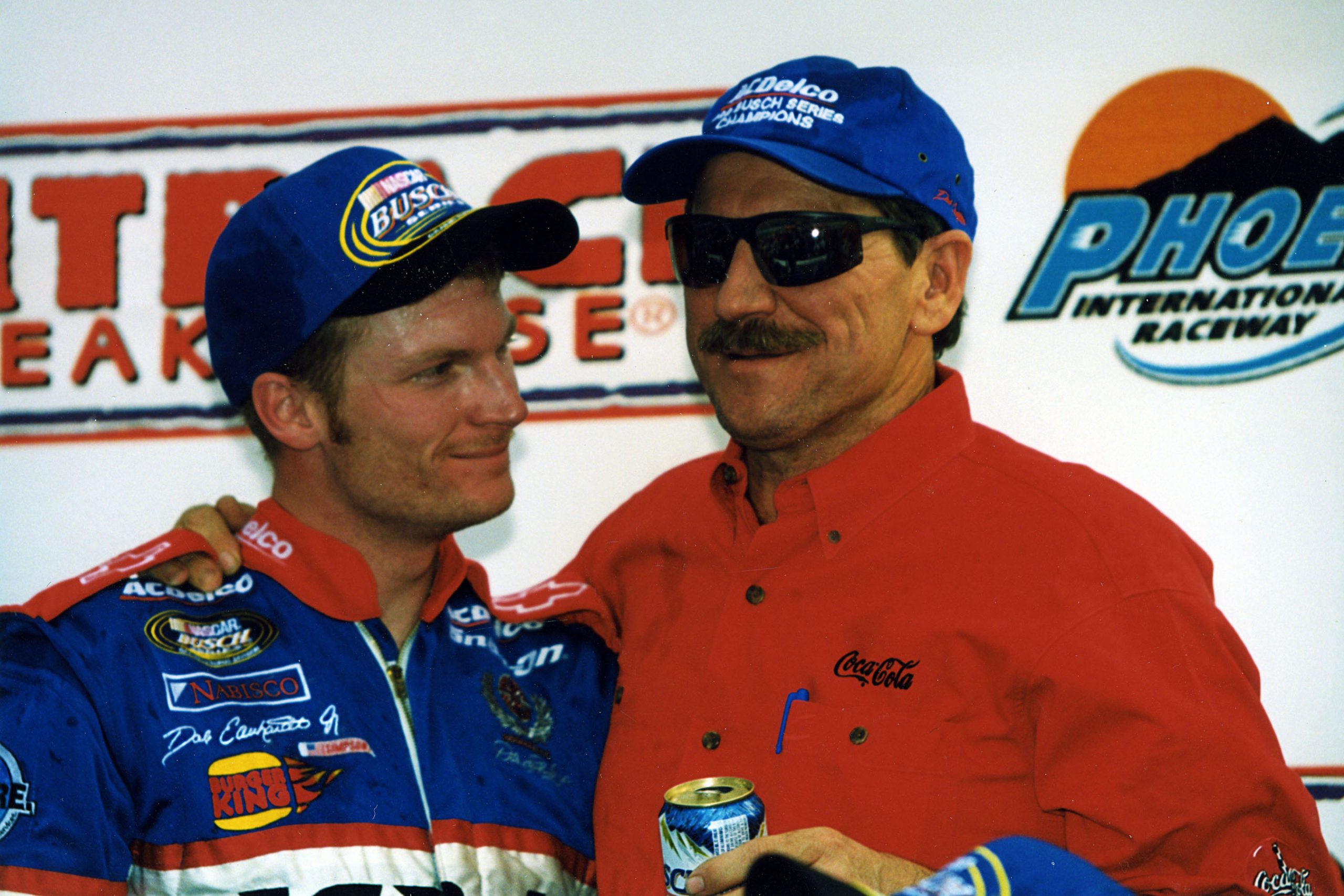 Dale Earnhardt Jr. poses with his father Dale Earnhardt Sr. in 1999.