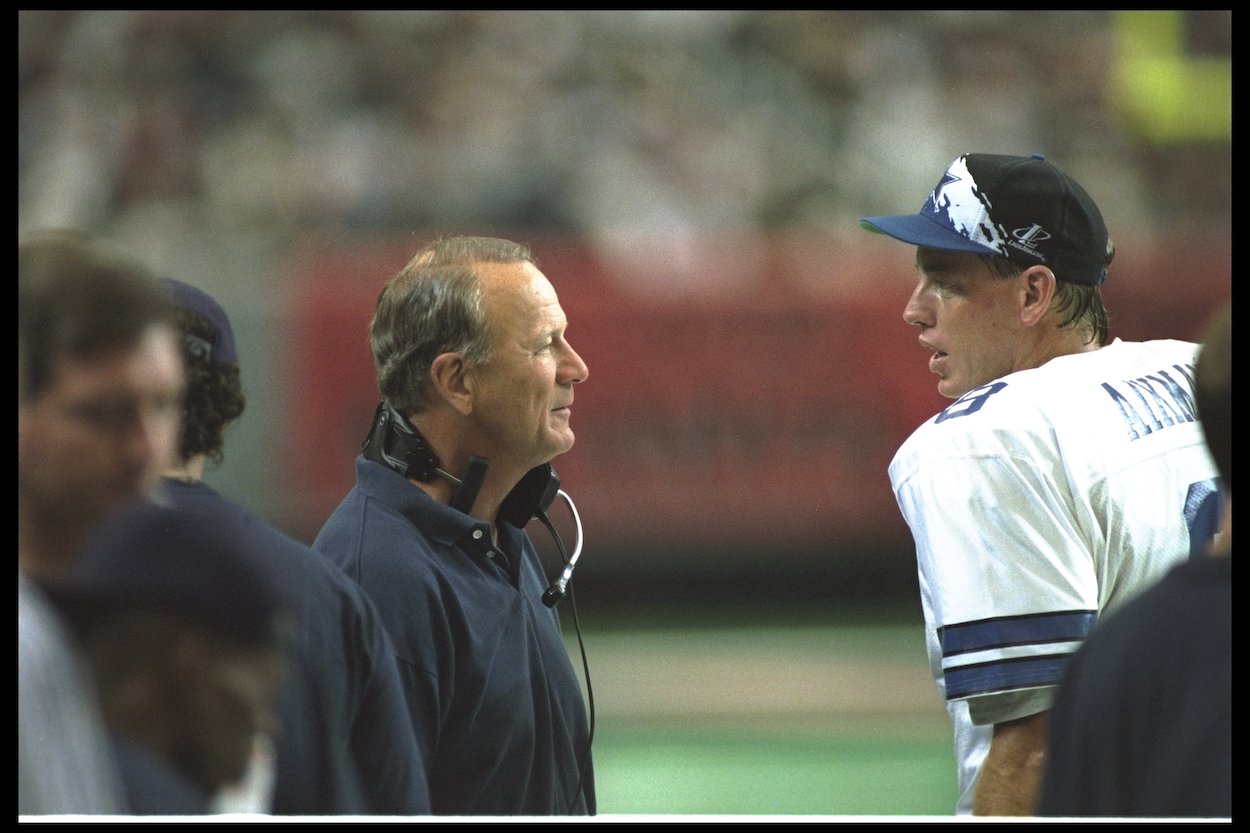 Dallas Cowboys quarterback Troy Aikman and head coach Barry Switzer talk during a game in 1995