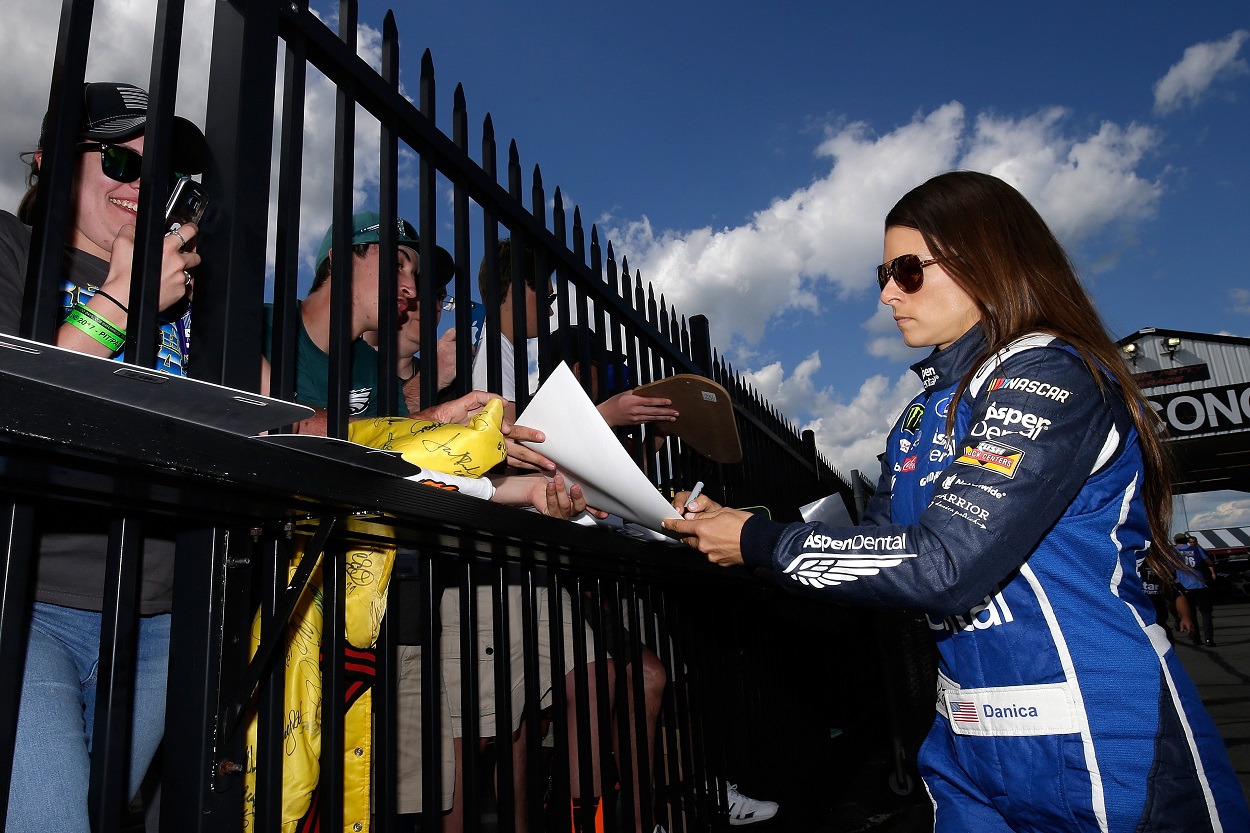 Danica Patrick signs autographs ahead of qualifying for the 2017 NASCAR Cup Series Pocono 400