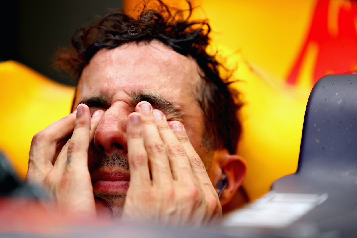 Daniel Ricciardo wipes the sweat from his eyes during practice