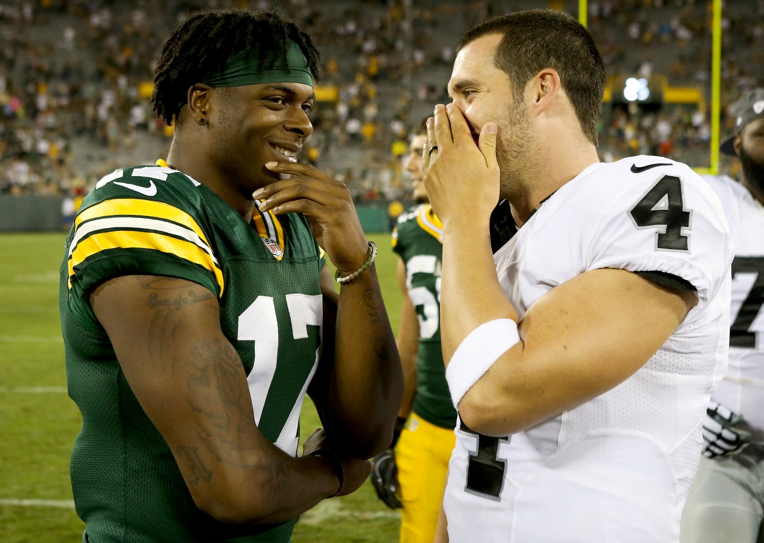 Packers WR Davante Adams speaks with Raiders QB Derek Carr after a game.